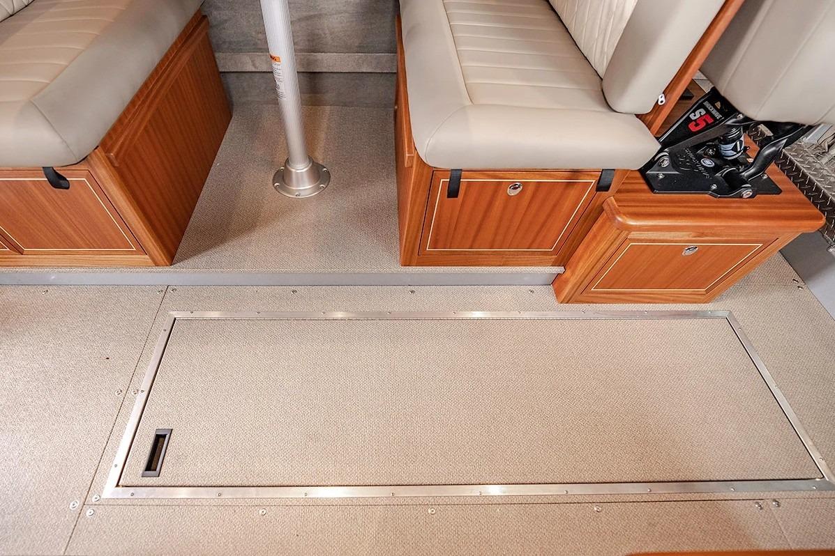 Interior of 2026 KingFisher 3225 GFX Offshore boat with cushioned seating and storage compartments.