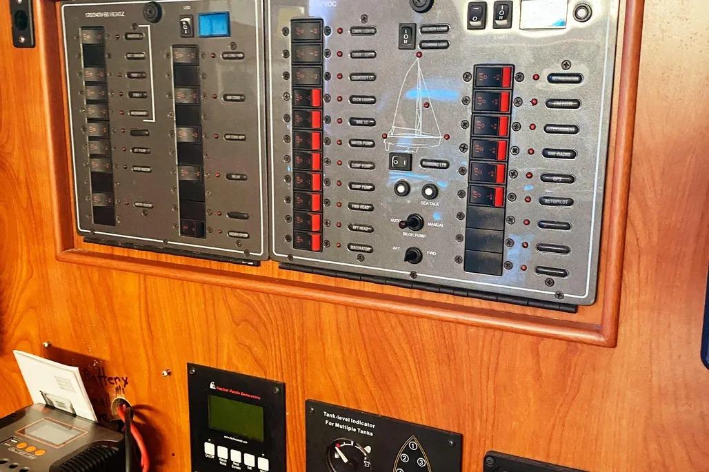 Control panel of a 2012 Hunter Aft Cockpit 50 yacht with various switches and indicators.