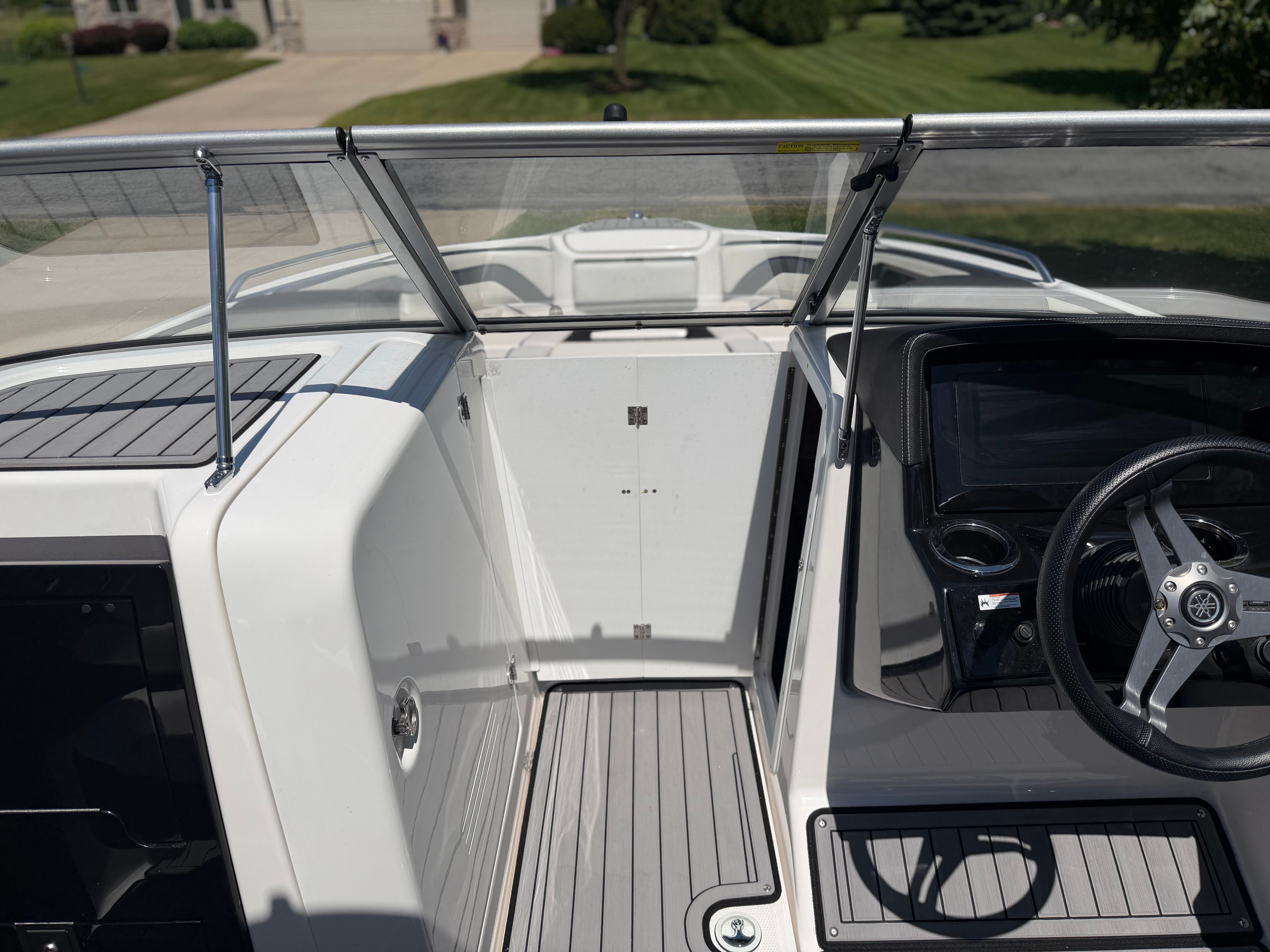 The image shows the cockpit of a 2018 Yamaha 242 Limited S boat with a modern helm.