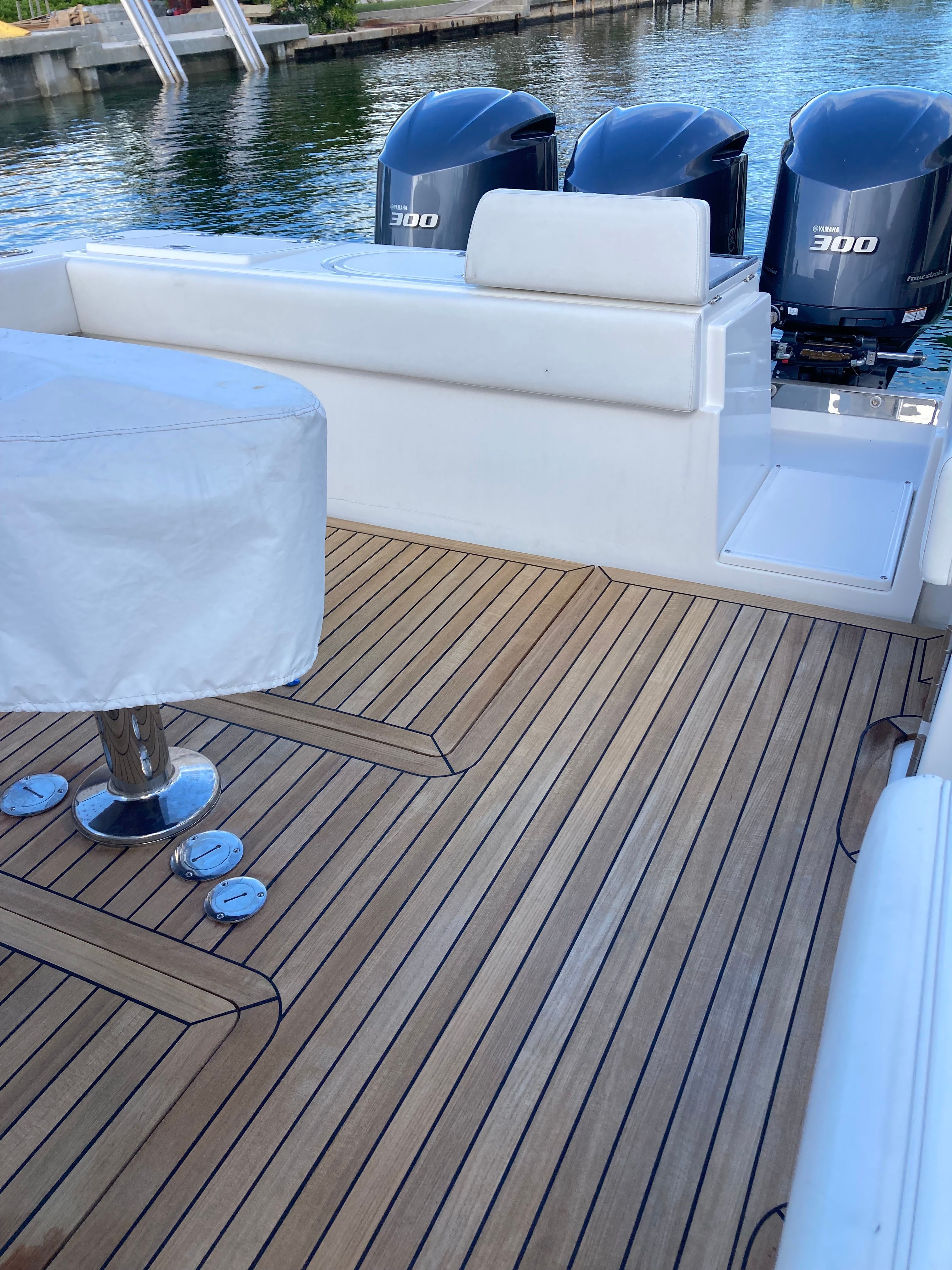 Venture CC 2019 boat with teak deck and outboard motors.