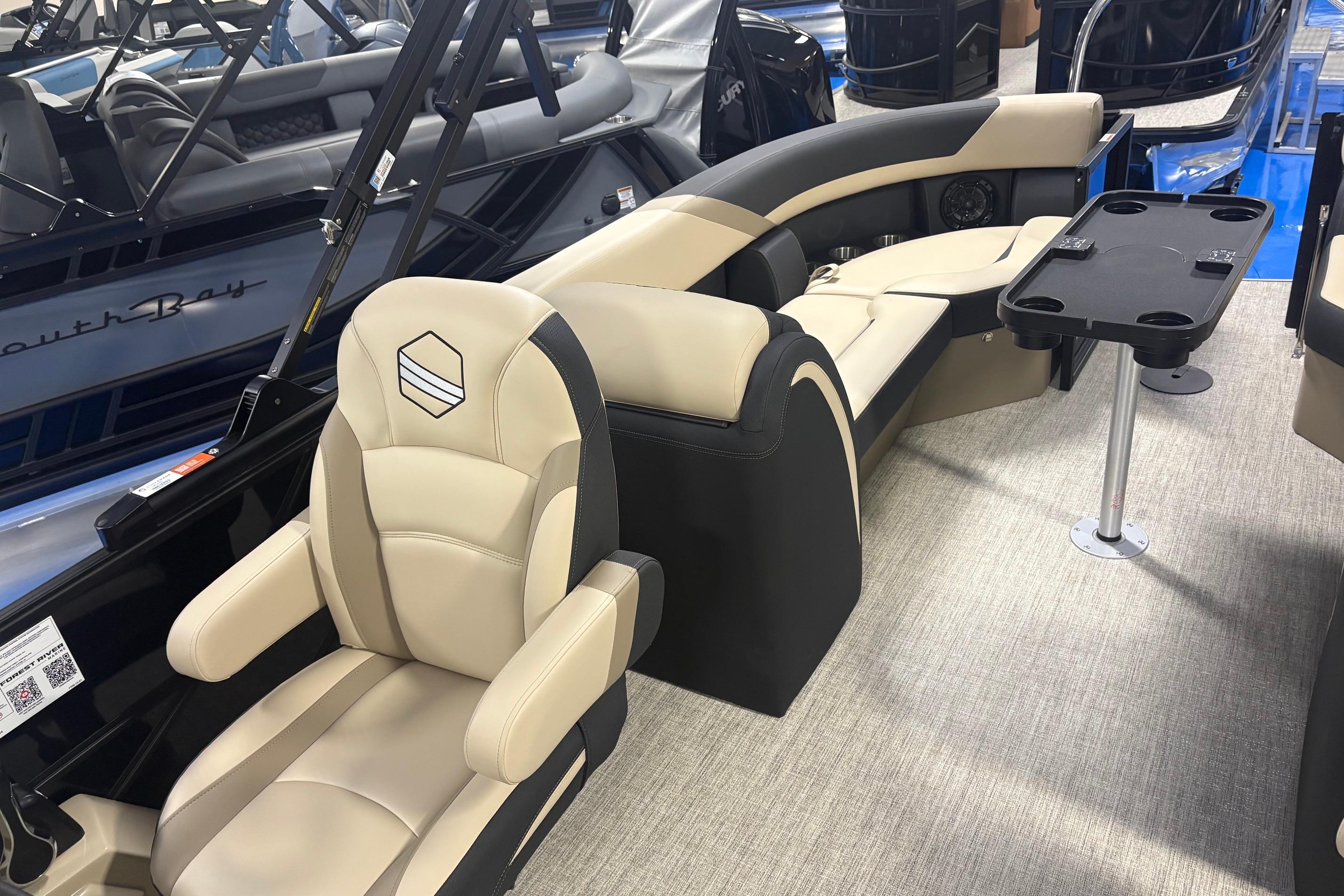 Luxurious interior of 2026 South Bay S224RS pontoon boat with plush seating and table.