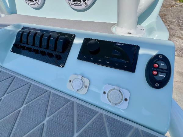 Control panel of 2022 Shallow Sport 20 Classic boat with switches and audio system.