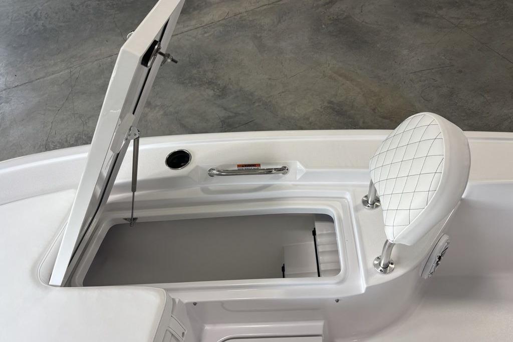 2026 Sportsman Masters 247 Bay Boat with open storage compartment and cushioned seat.