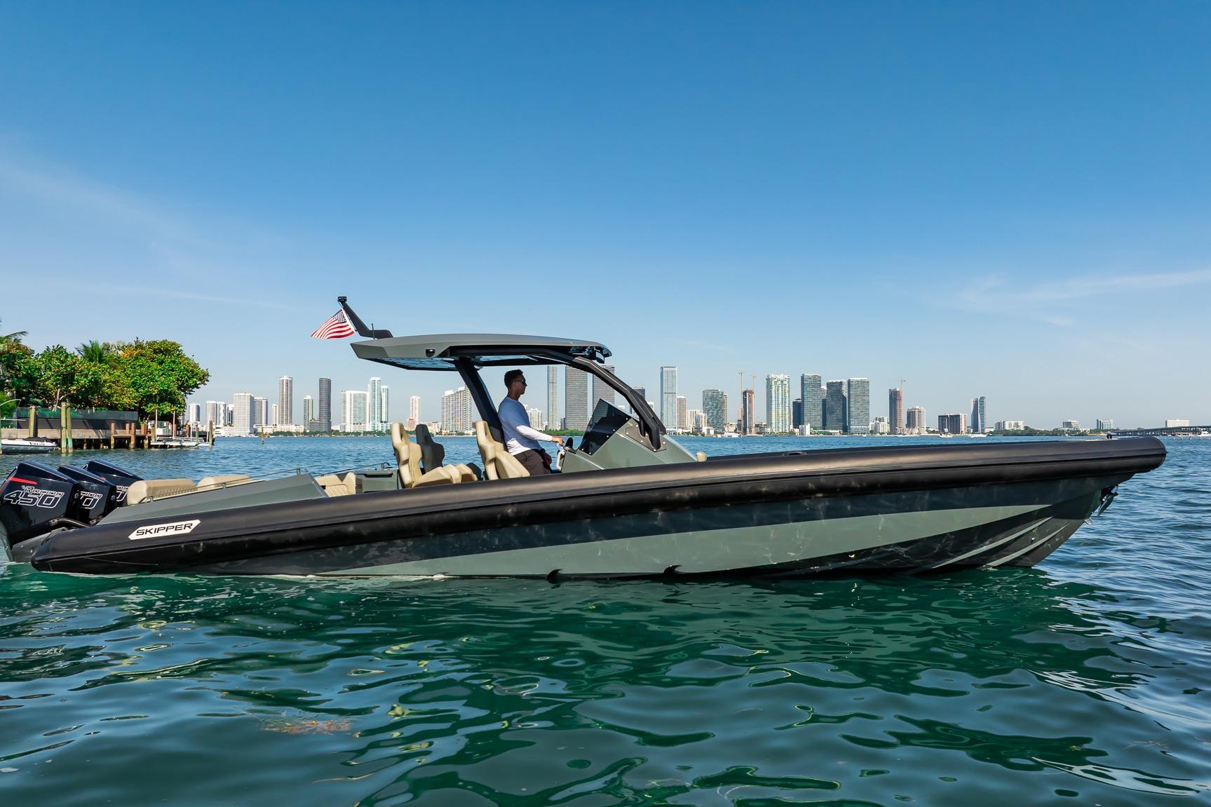 2023 Skipper-BSK 38NC boat cruising near city skyline on a sunny day.