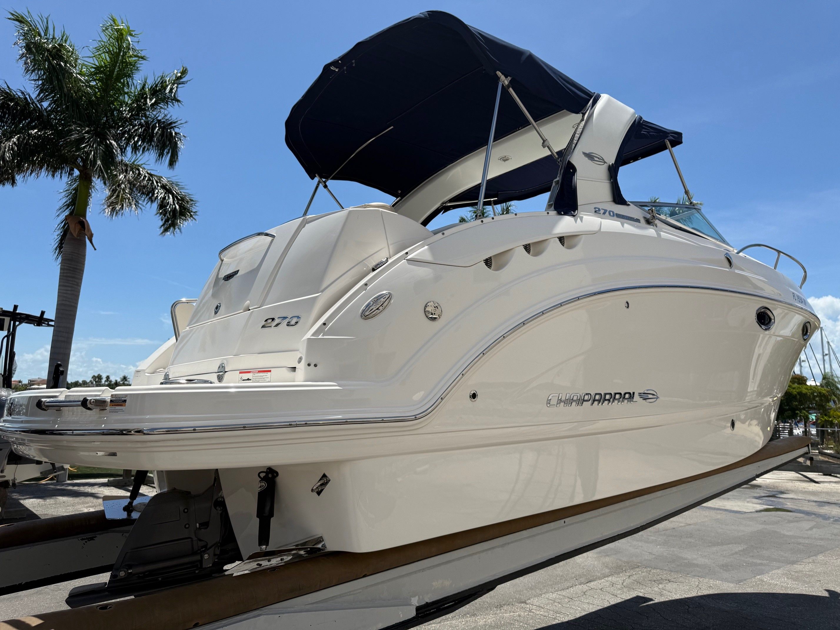 2018 Chaparral 270 Signature boat on trailer under palm trees.