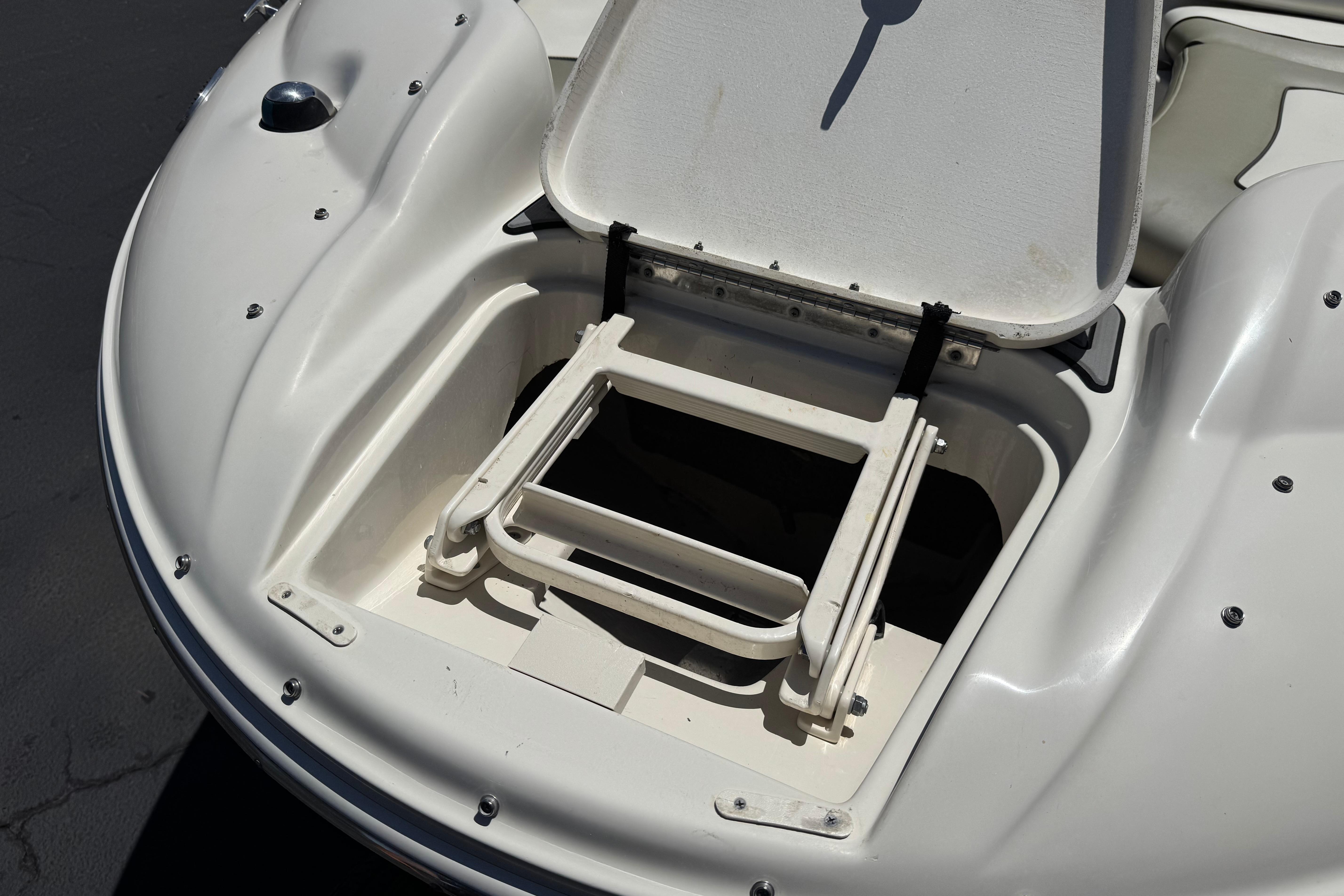 Open storage compartment on a 2007 Sea Ray 240 Sundeck boat.