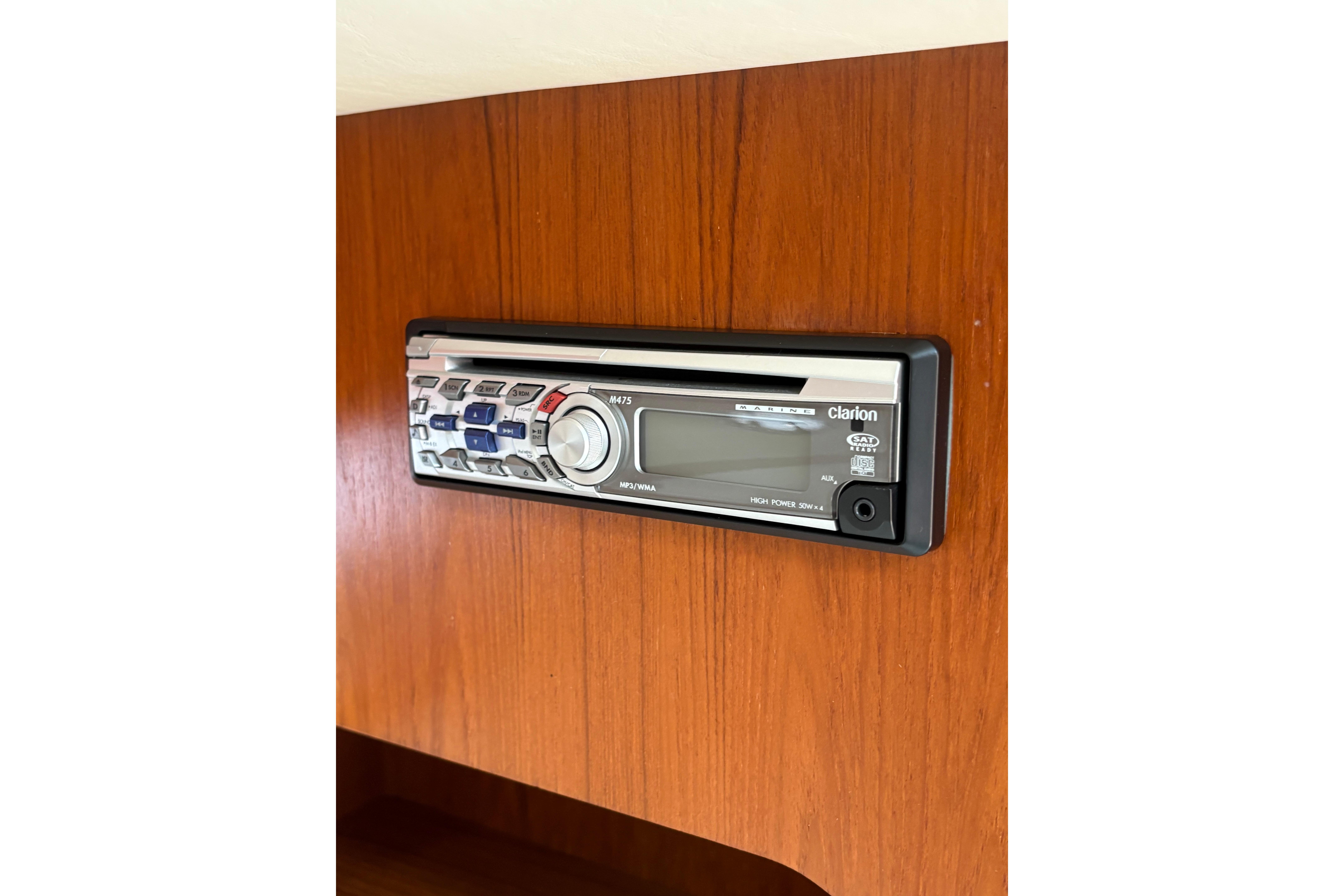 Clarion stereo system in 1999 Tiara Yachts 3100 Open, mounted on wooden panel.