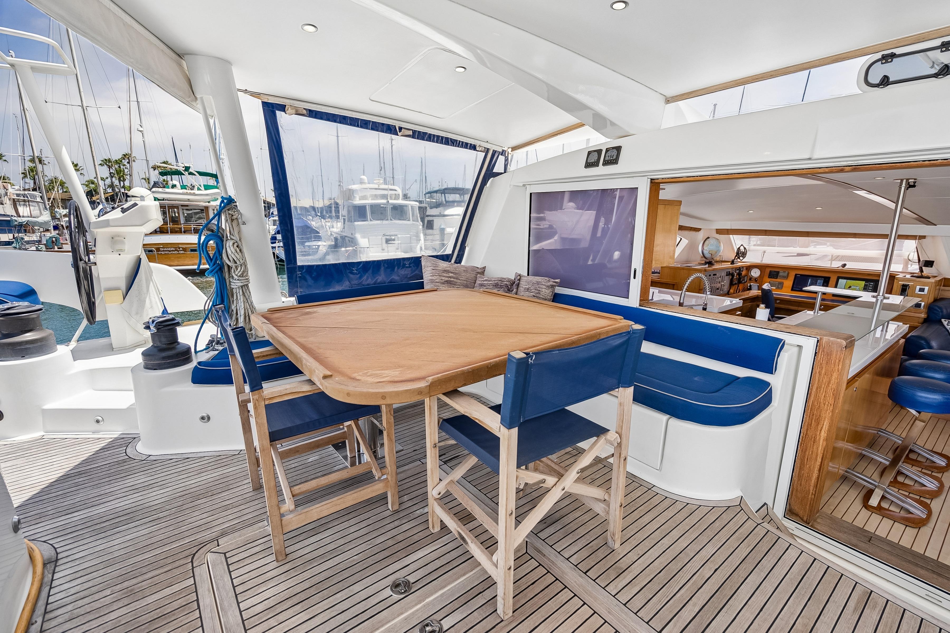 Luxurious 2009 Catana 65 yacht interior with elegant dining area and modern design.