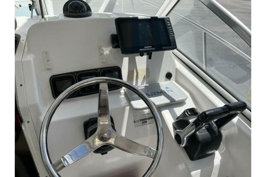 Helm of 2006 Century 2400 Walk-Around boat with Garmin navigation system.