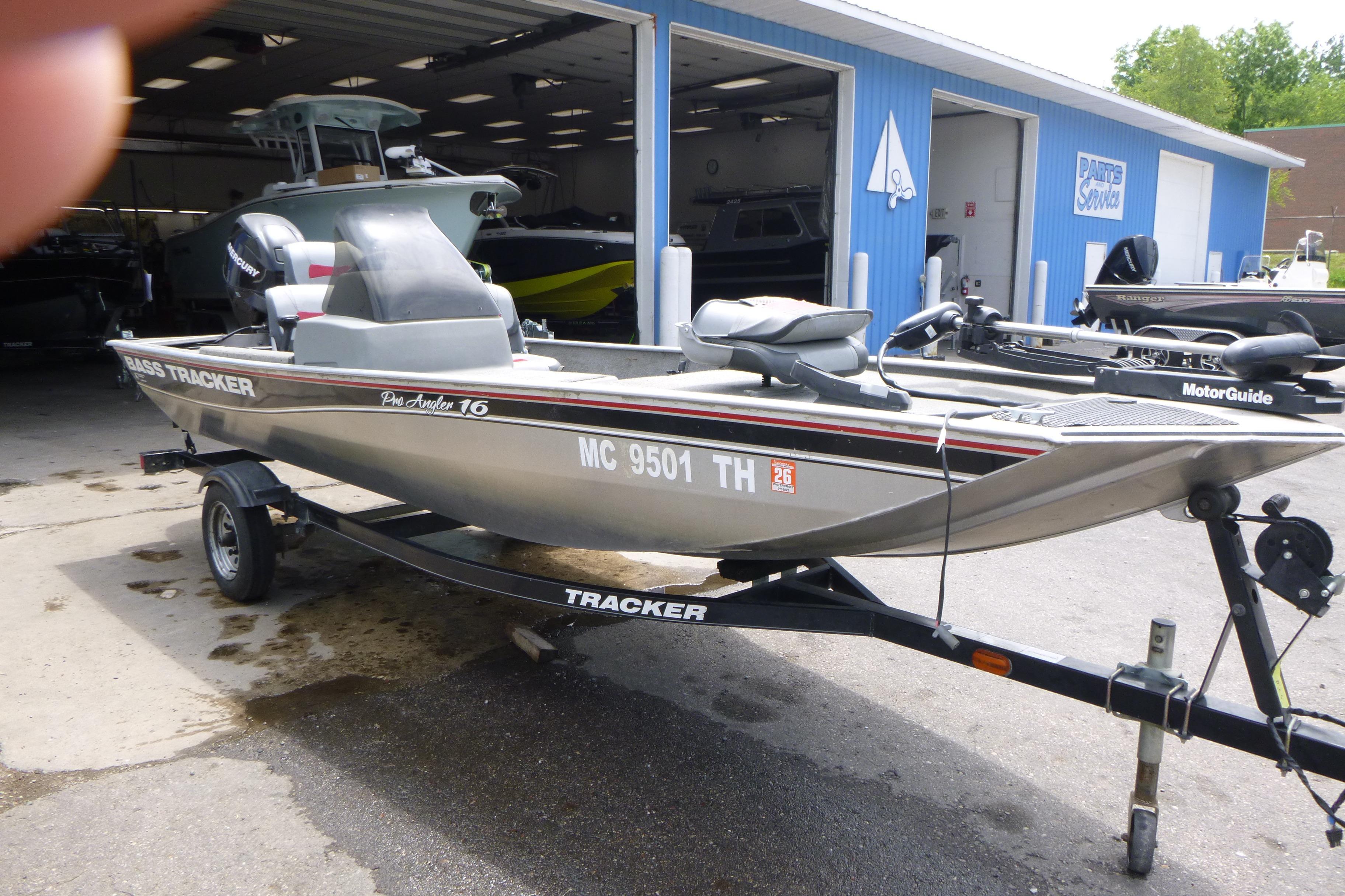 2011 Tracker Pro Angler 16 boat on trailer outside service shop.