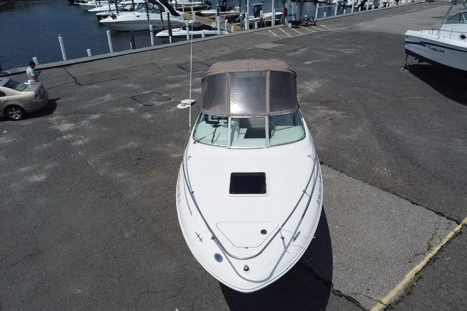 2001 Sea Ray 245 Weekender boat docked at marina, aerial view.