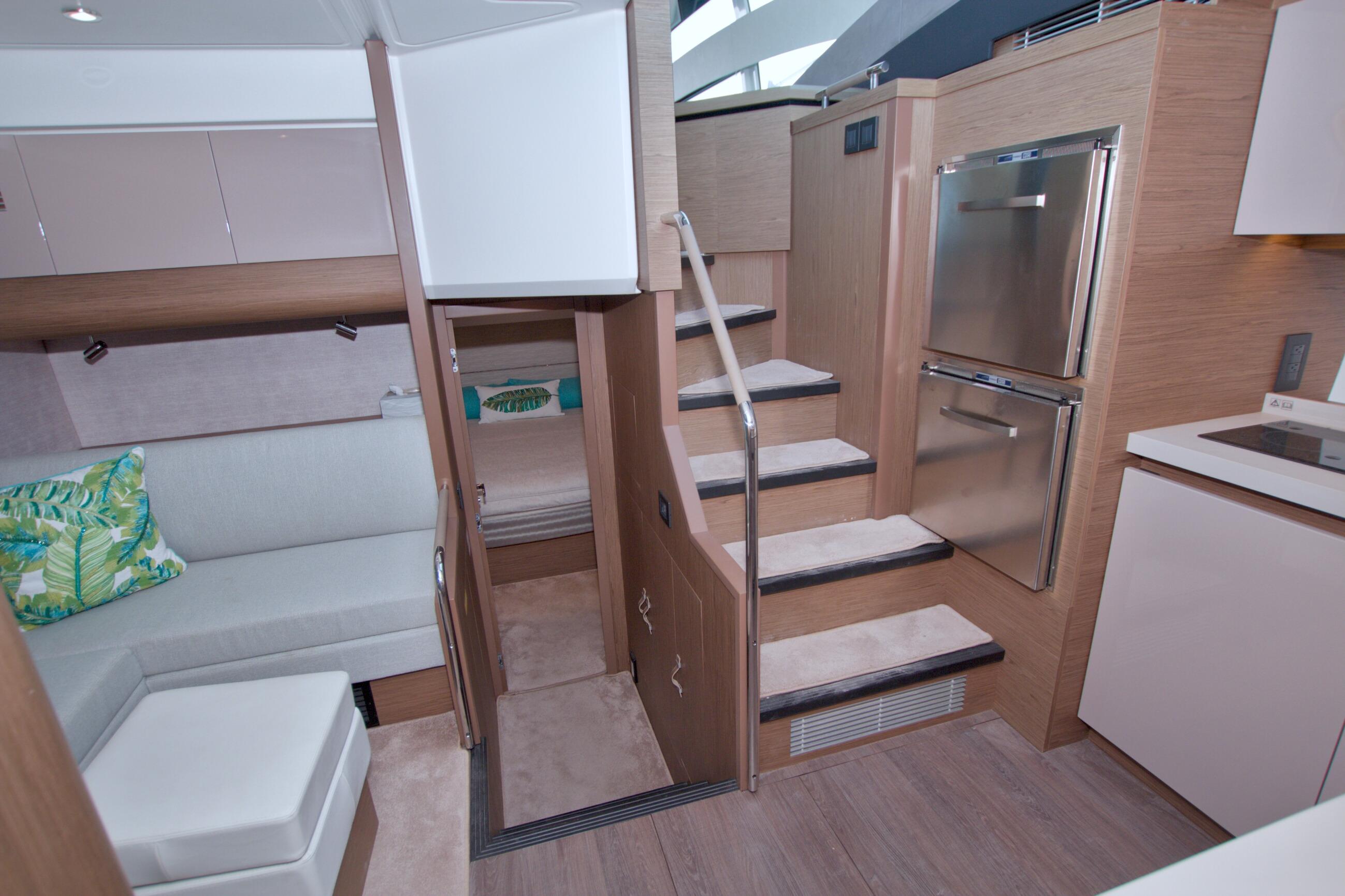 Luxurious interior of 2019 Beneteau Gran Turismo 50 yacht with modern kitchen and seating area.