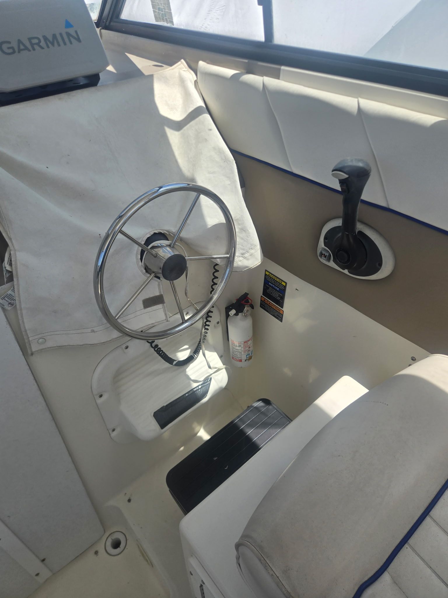 Cockpit of a 2003 Bayliner 28 boat with Garmin equipment.
