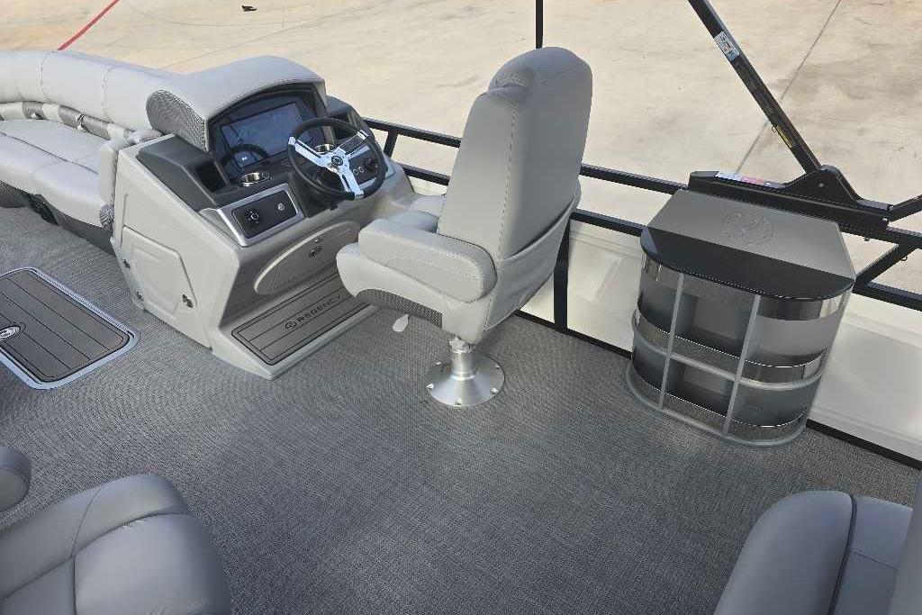 2025 Regency 250 LE3 Sport boat interior with steering console and seating.