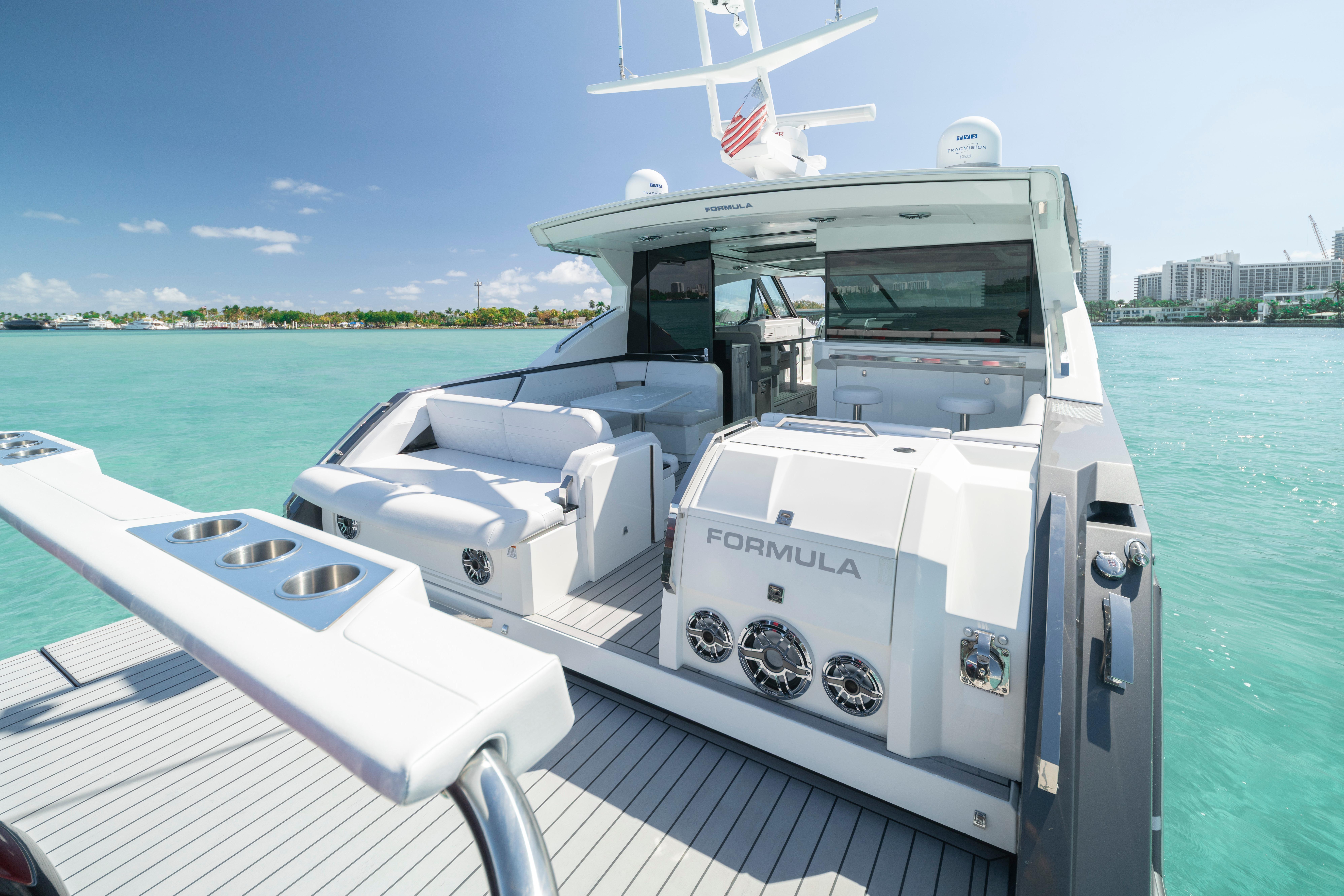 2022 Formula 500 Super Sport Crossover yacht on turquoise water, featuring luxurious seating and amenities.