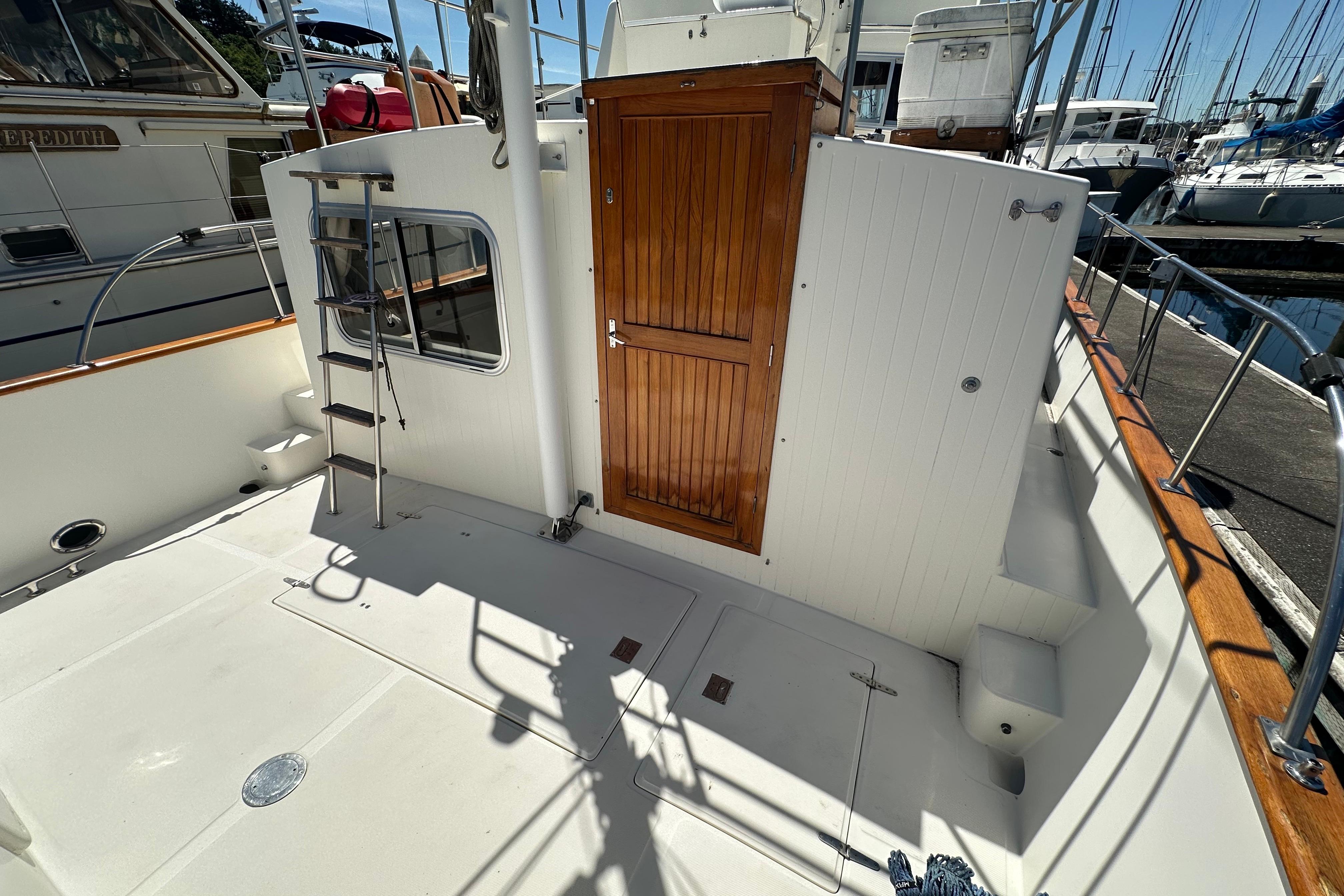 Eagle 40 Pilothouse Trawler 2000, featuring a wooden door and ladder on deck.
