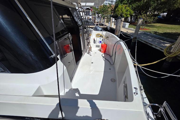 1993 McKinna 48 Pilothouse yacht docked, featuring spacious deck and modern amenities.