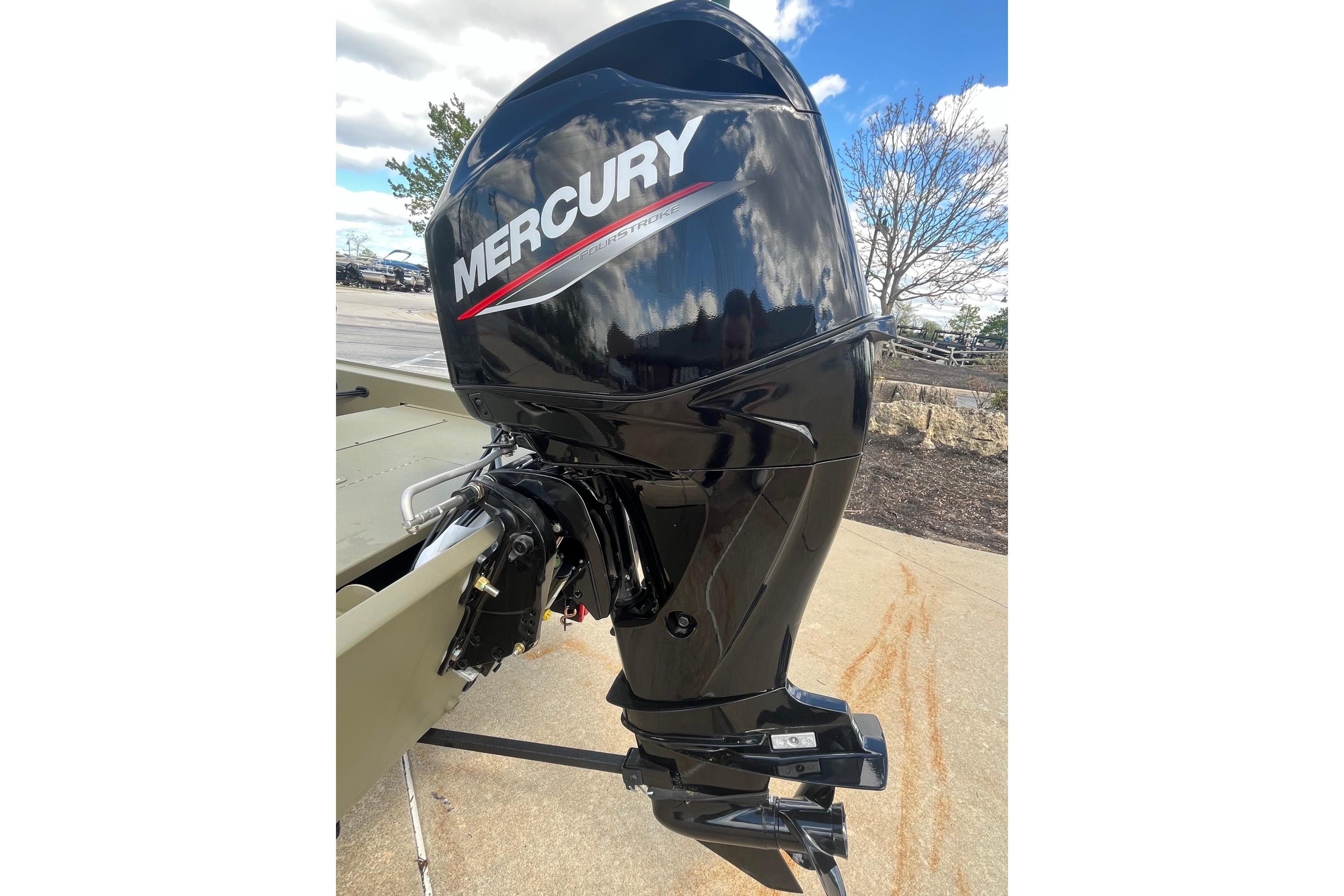 2026 Tracker Grizzly 1754 SC boat with Mercury outboard motor, parked outdoors.