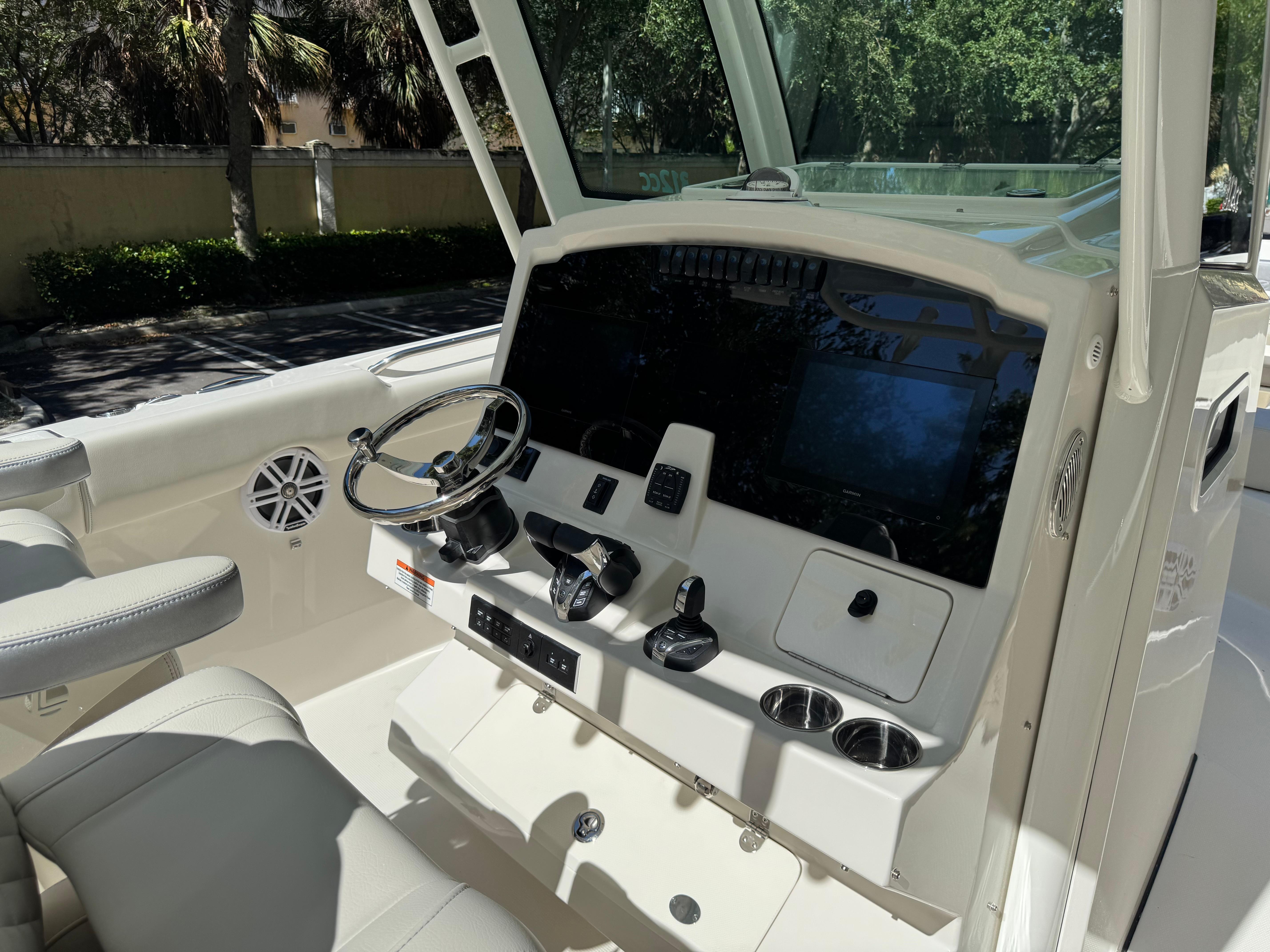2026 Sailfish 312 CC boat cockpit with steering wheel, controls, and seating.
