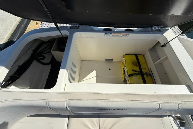 Storage compartment of 2022 Sea Ray SPX 210 Outboard boat with safety equipment.