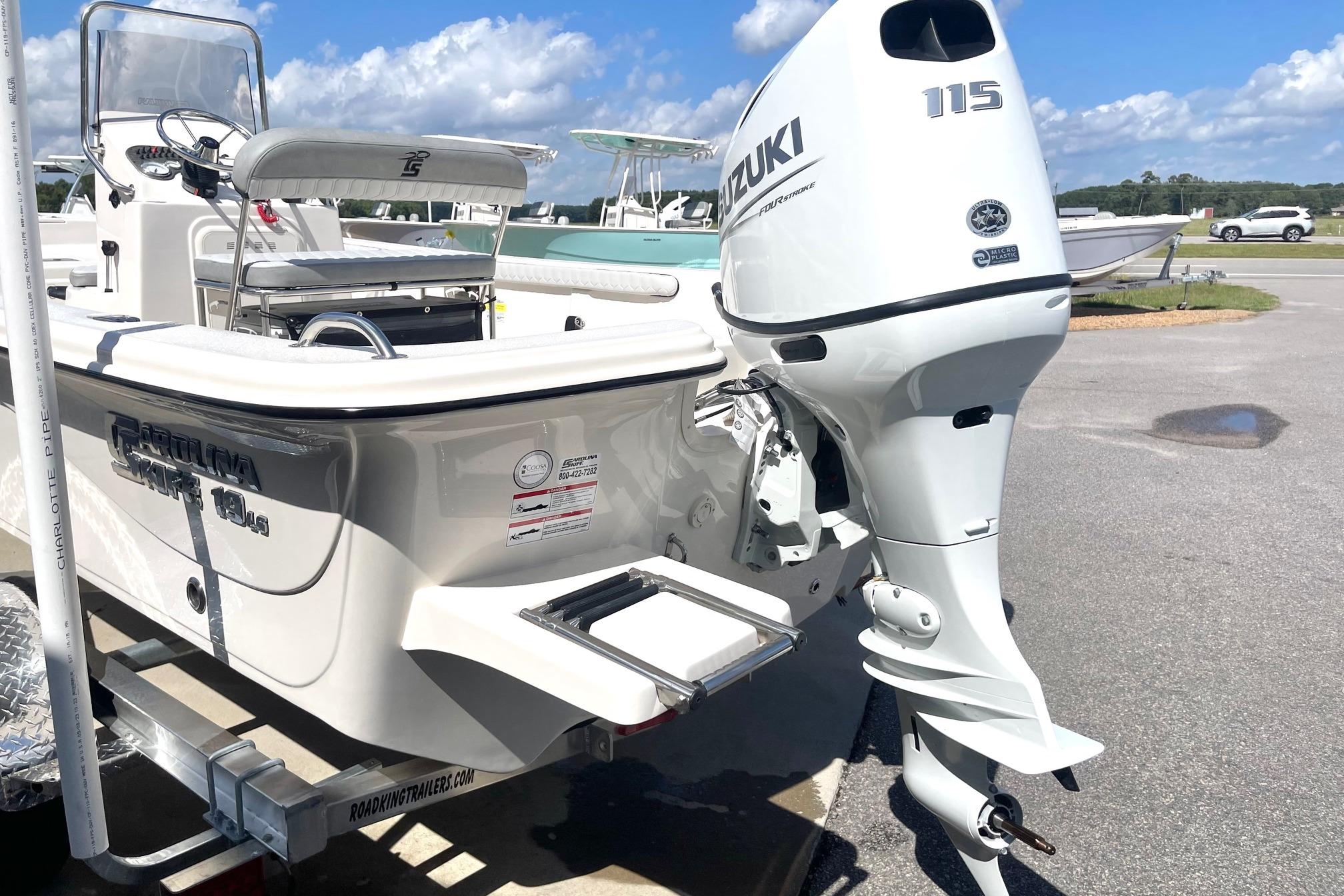 2026 Carolina Skiff 19 LS boat with Suzuki 115 outboard motor, parked on a trailer.