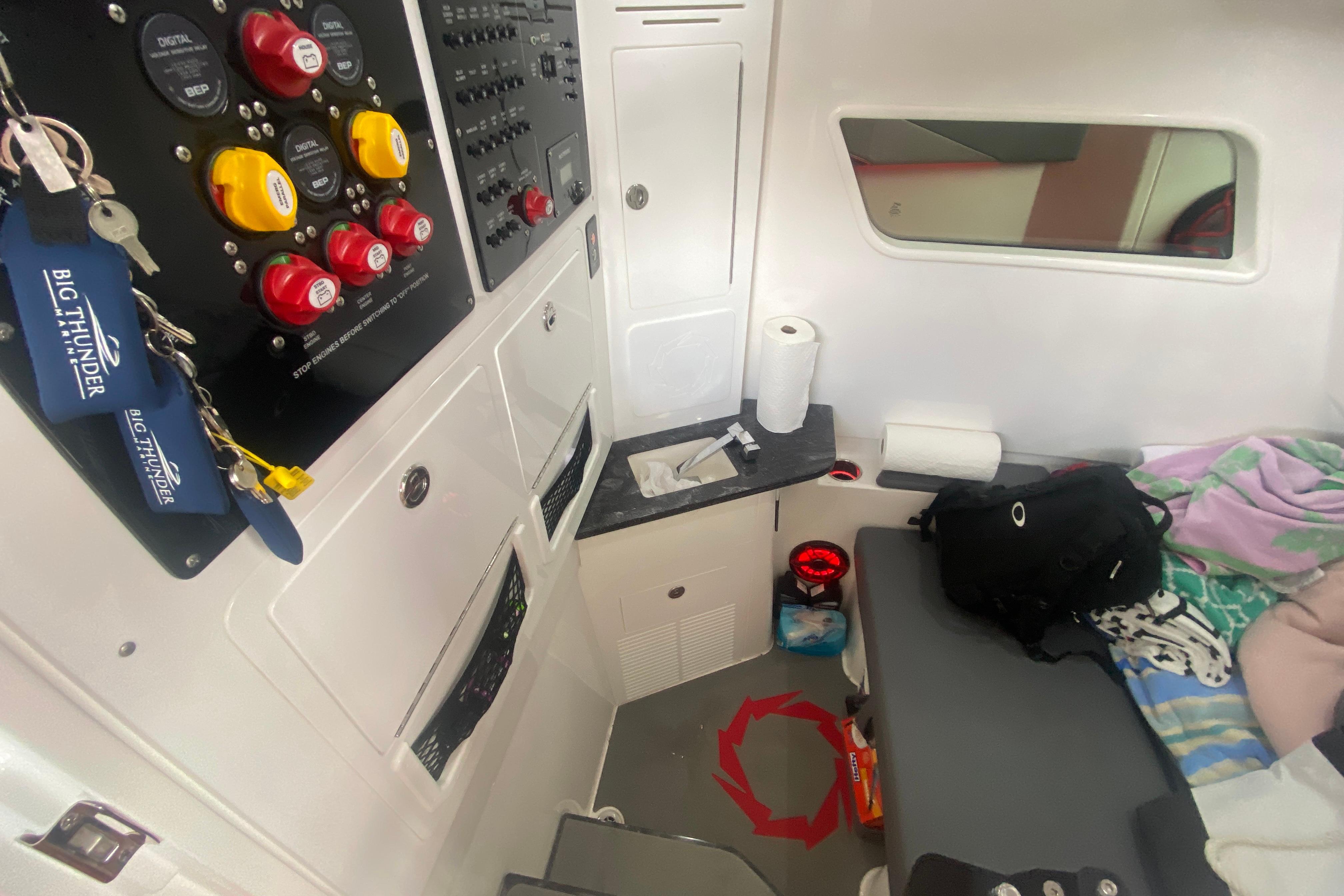 Interior of a 2025 Fountain 38 SCX boat with control panel and seating area.