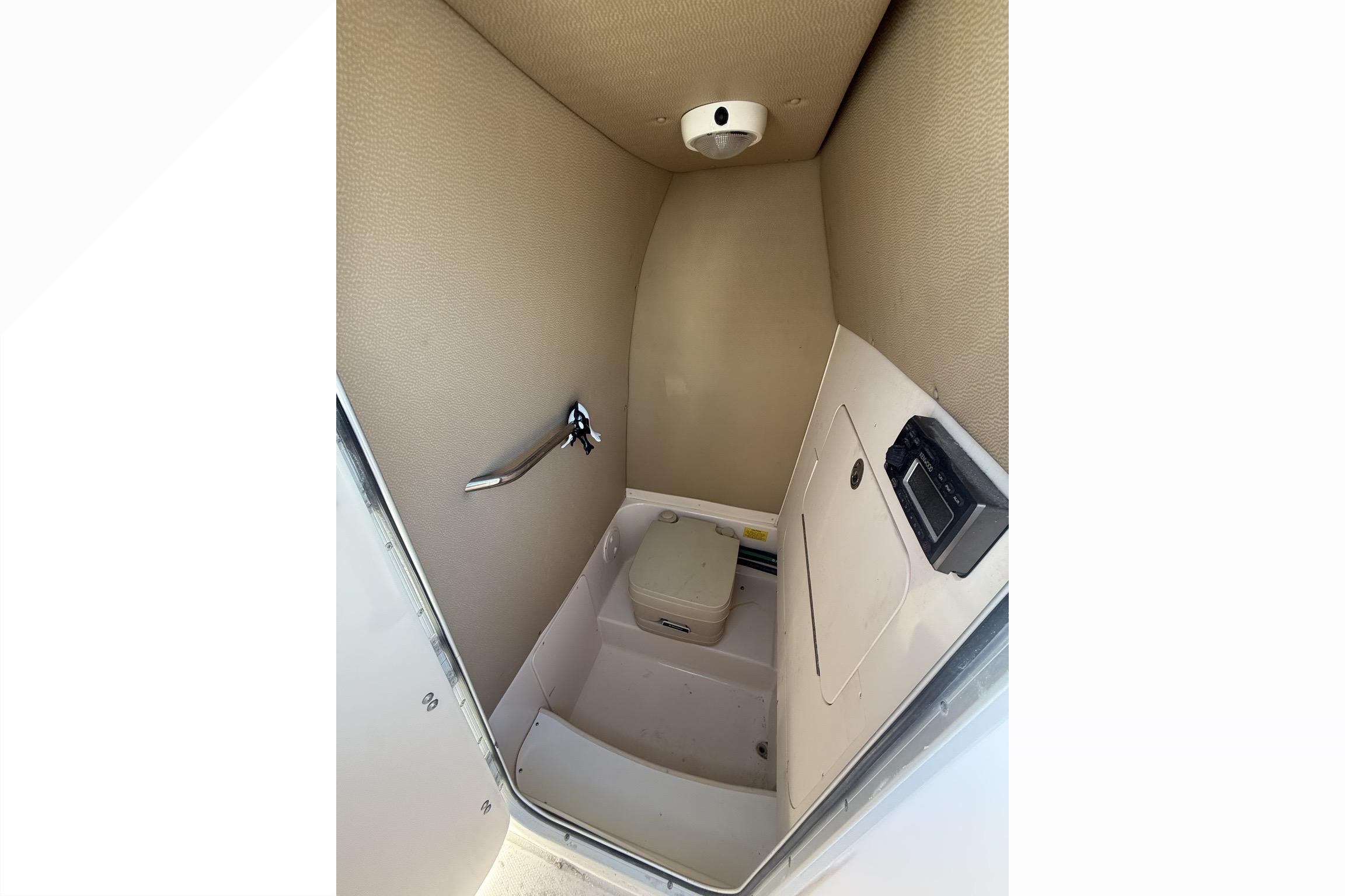 2011 Grady-White Fisherman 230 boat interior with compact marine toilet.