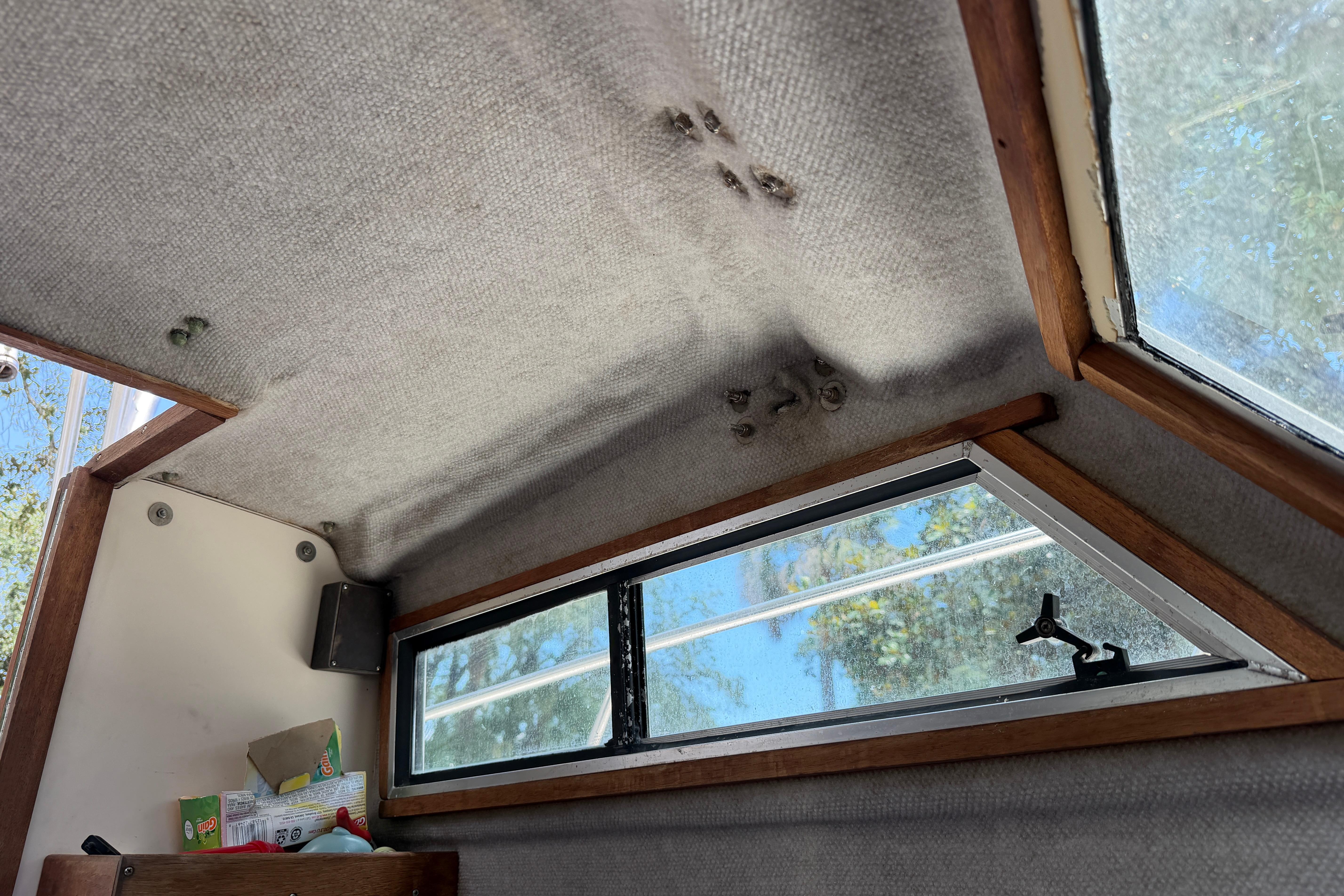 Interior cabin view of a 1987 Grady-White Seafarer 226 boat with windows and storage.