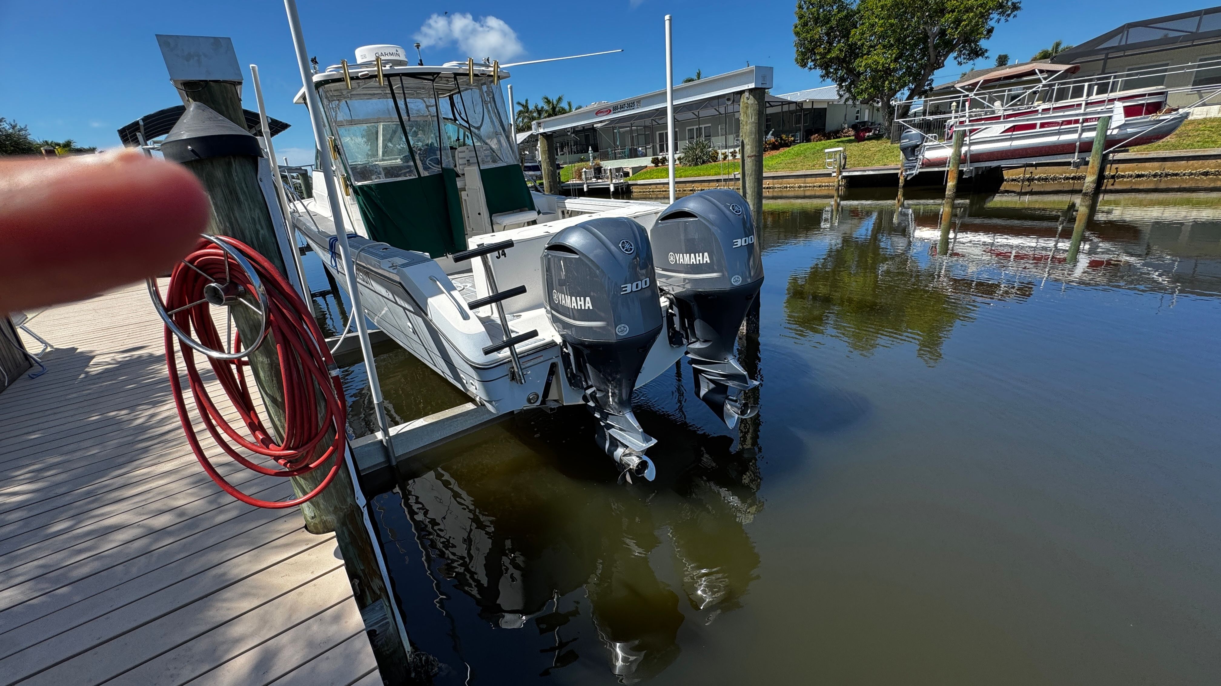 2003 Pursuit 3070 at dock with twin Yamaha outboard engines.