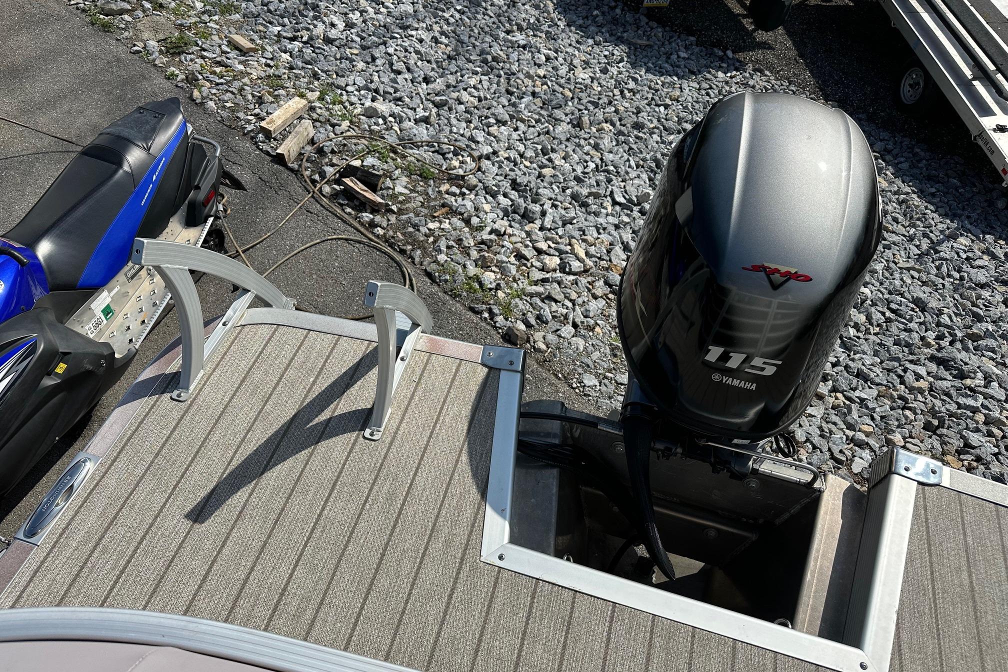 2017 Bennington 22 GPD boat with Yamaha 115 outboard motor on gravel surface.