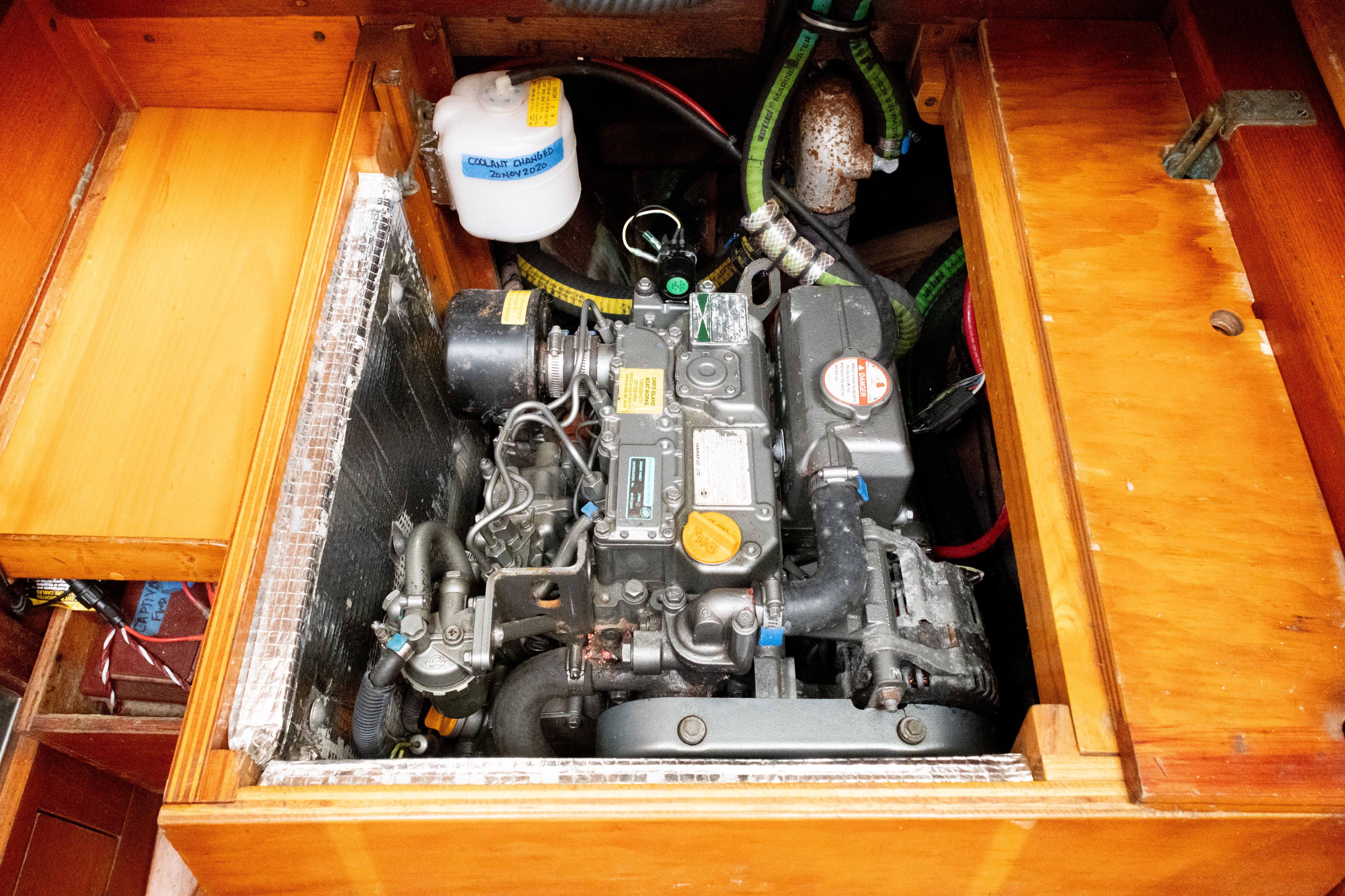 Engine compartment of a 1965 Concordia 39 sailboat, showcasing detailed mechanical components.
