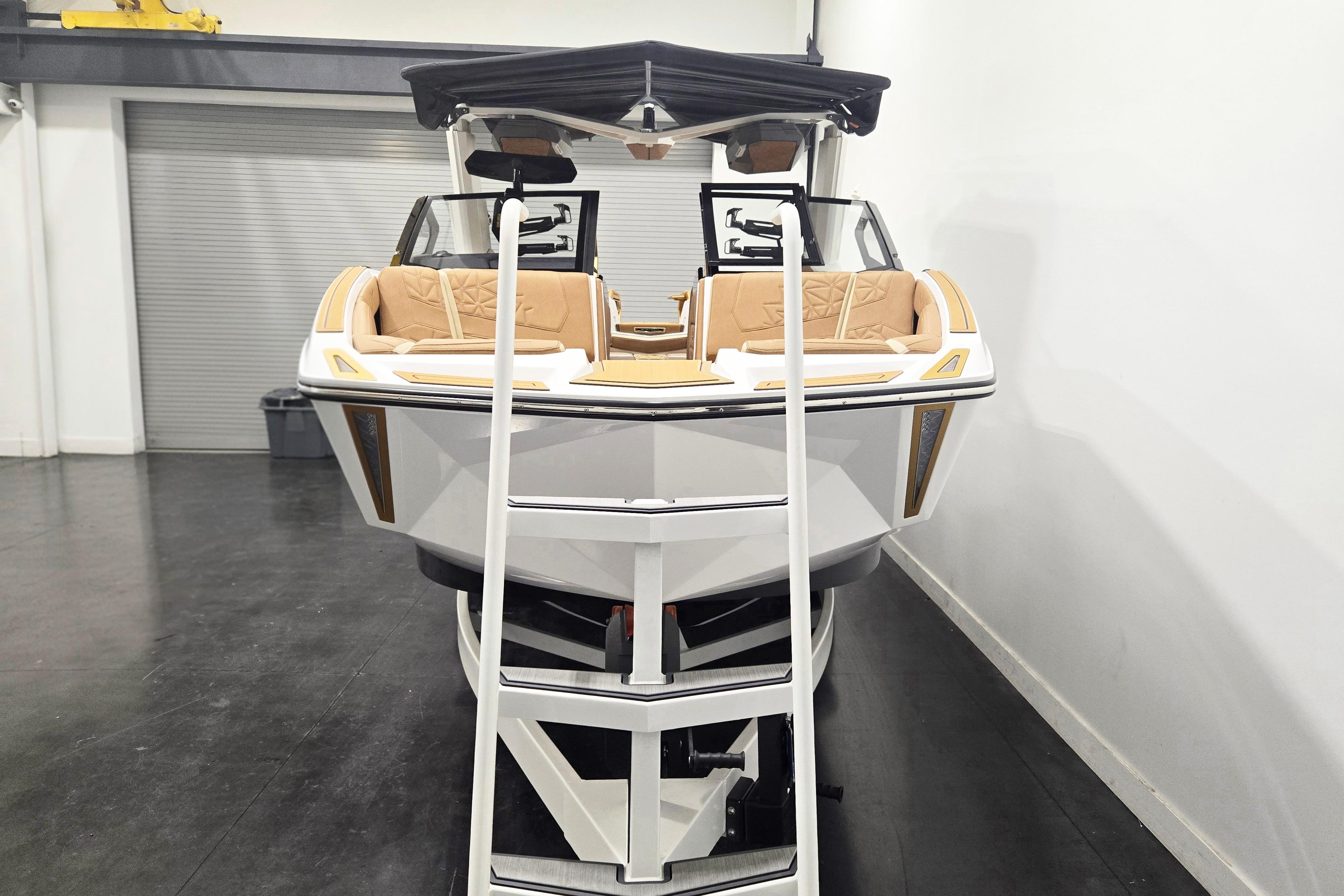 2026 Nautique Super Air Nautique G23 Paragon boat in showroom, featuring luxurious seating and sleek design.