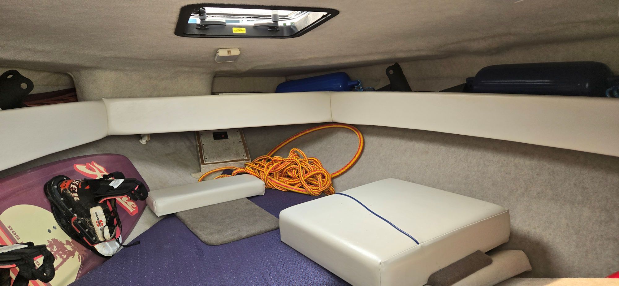 Interior of a 2004 Bayliner B210 Classic with rope and wakeboard.