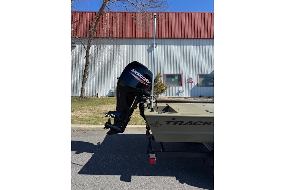 2026 Tracker Grizzly 1648 SC boat with Mercury outboard motor, parked outdoors.