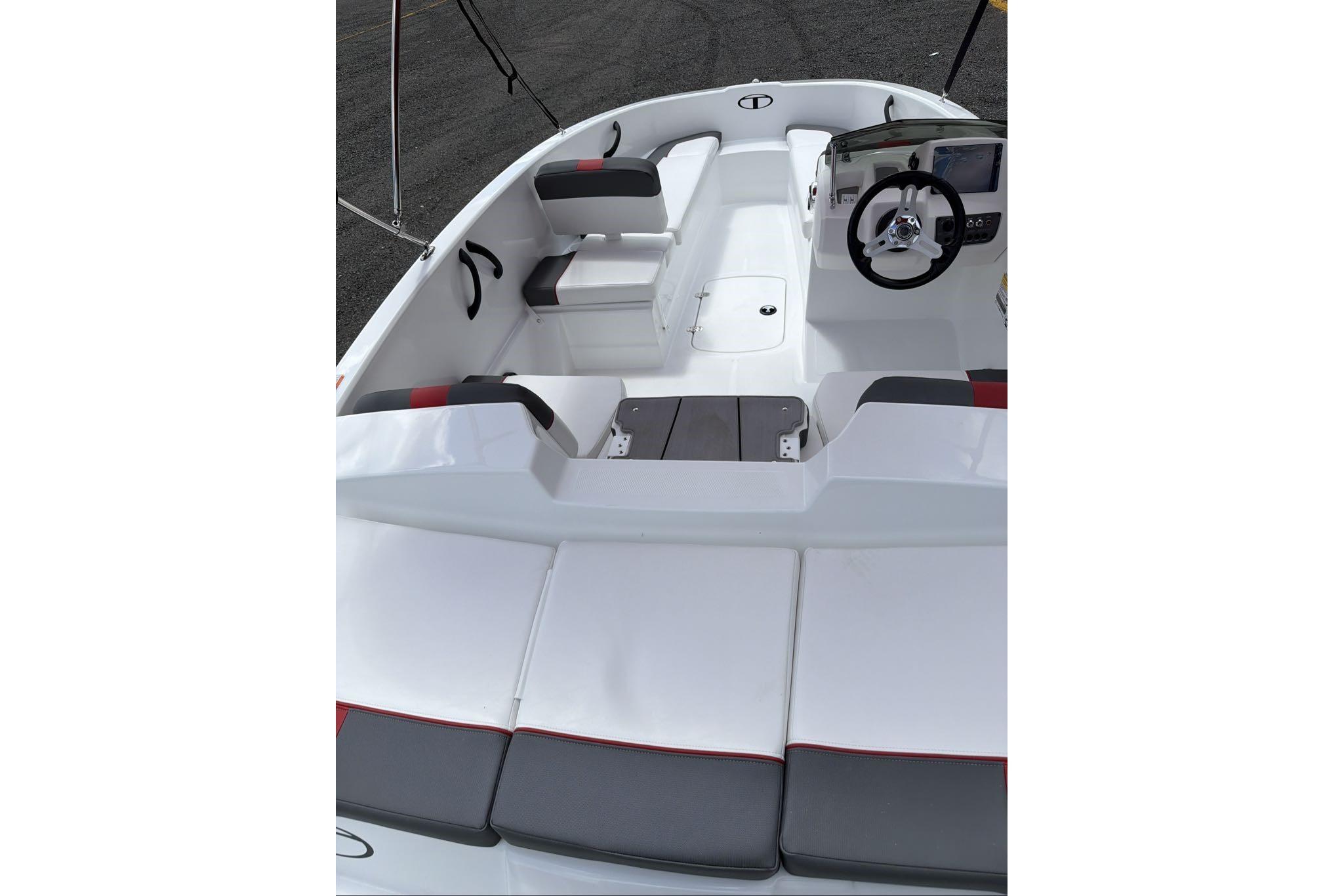 2026 Tahoe T16 boat interior with seating and steering wheel, showcasing modern design.