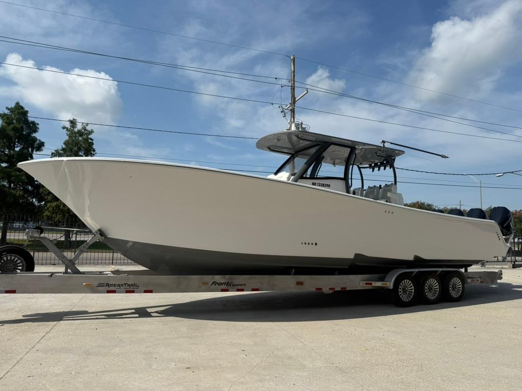 2024 Front Runner 39 CC boat on trailer under clear sky.