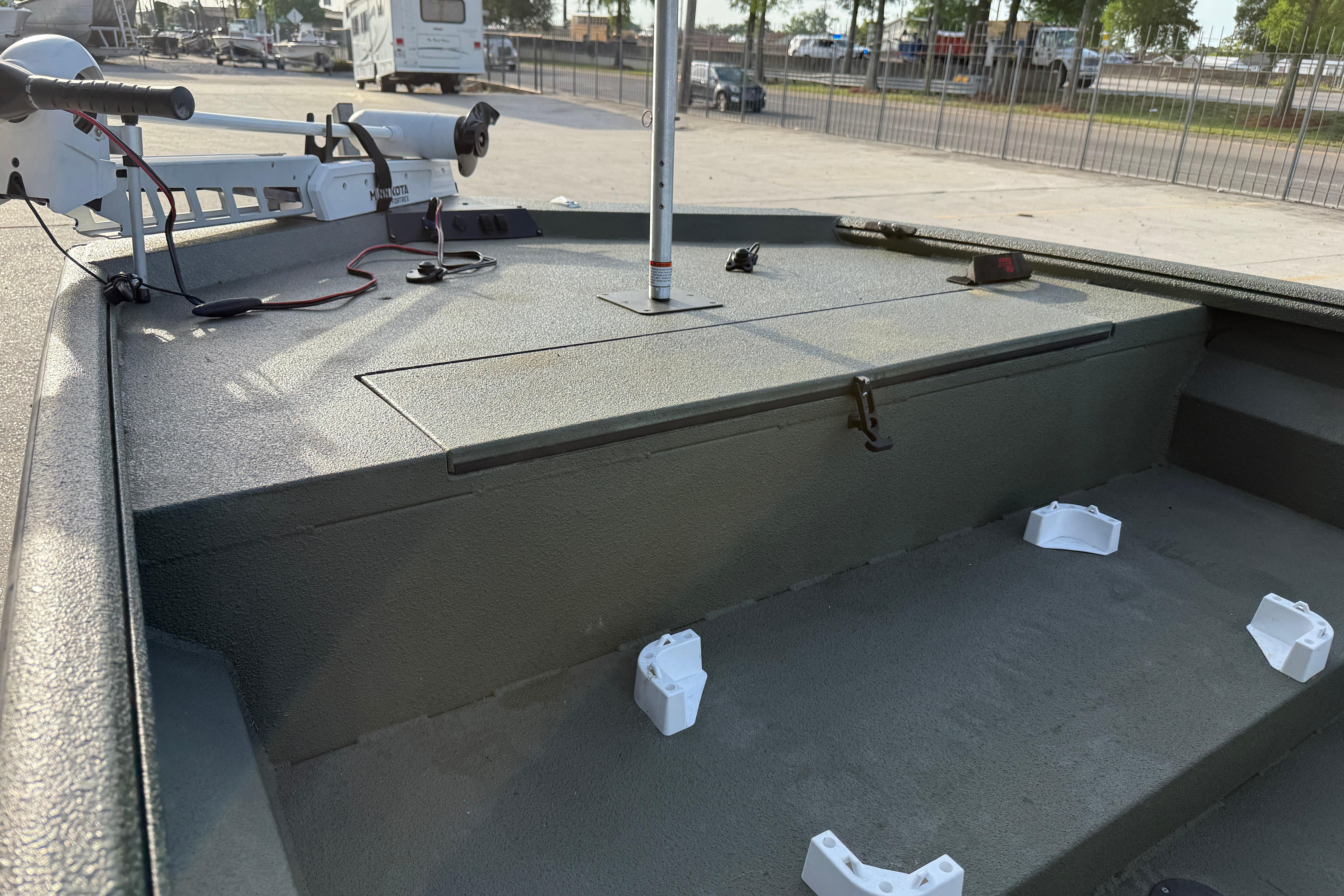 2014 Excel 203 Bay Pro boat deck with trolling motor in a parking area.