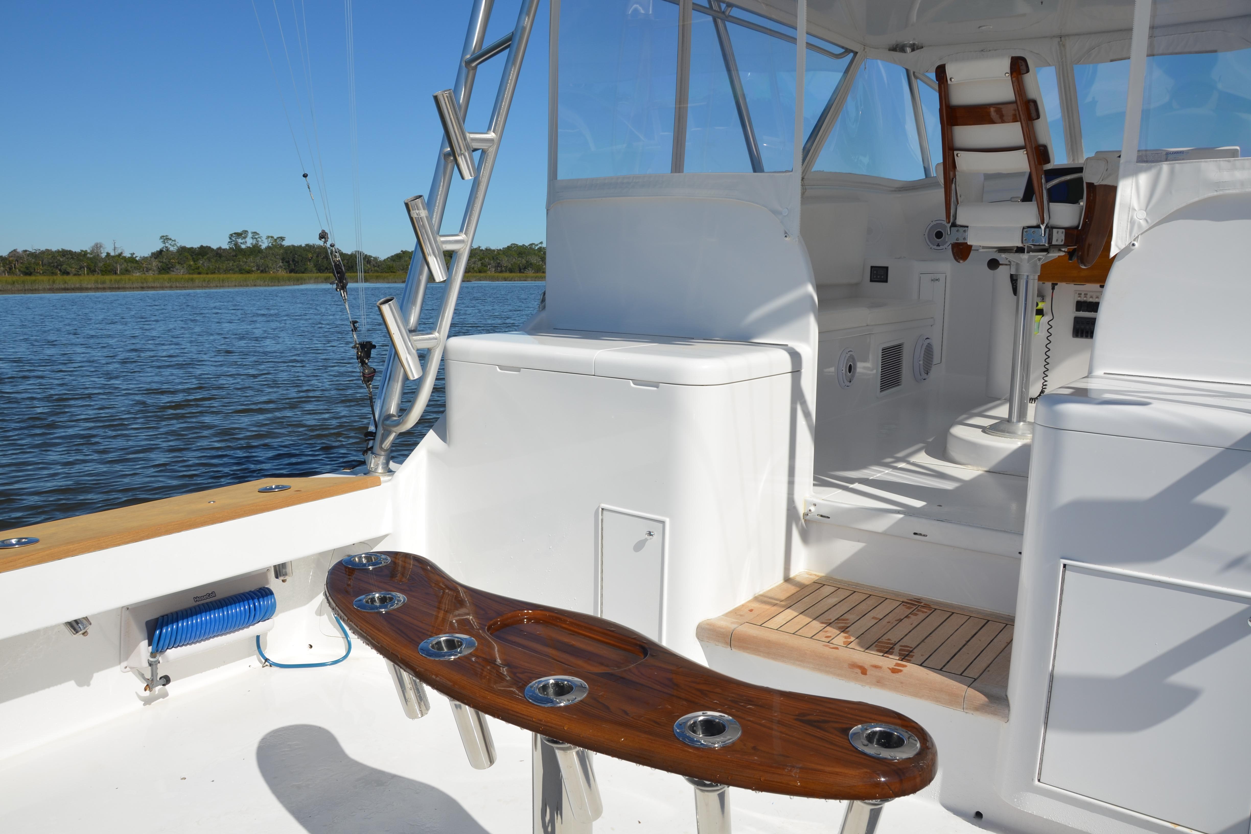 2006 Custom Carolina Heritage Express boat interior with fishing rod holders and seating.