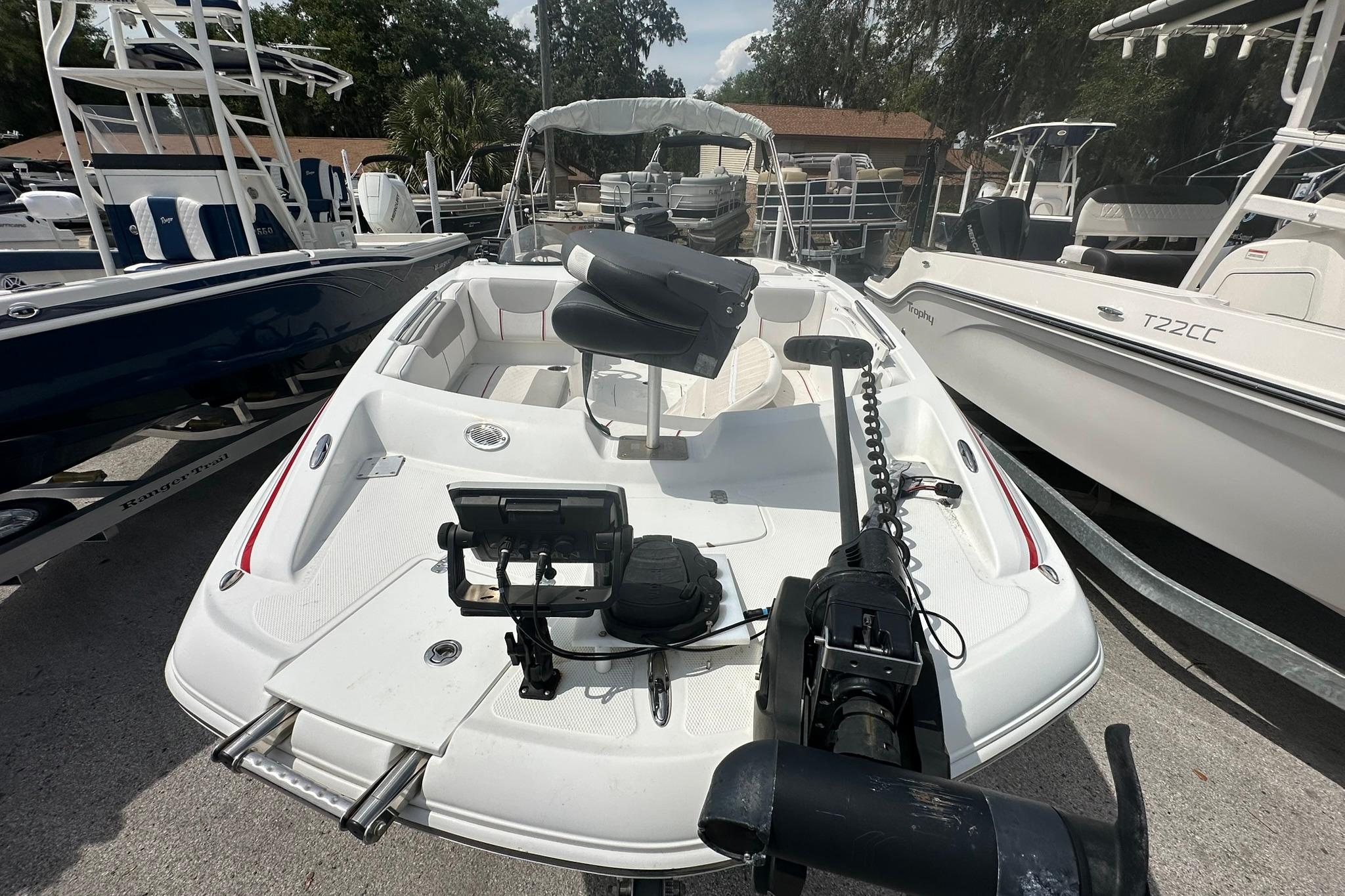 2021 Tahoe 2150 boat with seating and equipment, docked among other boats.