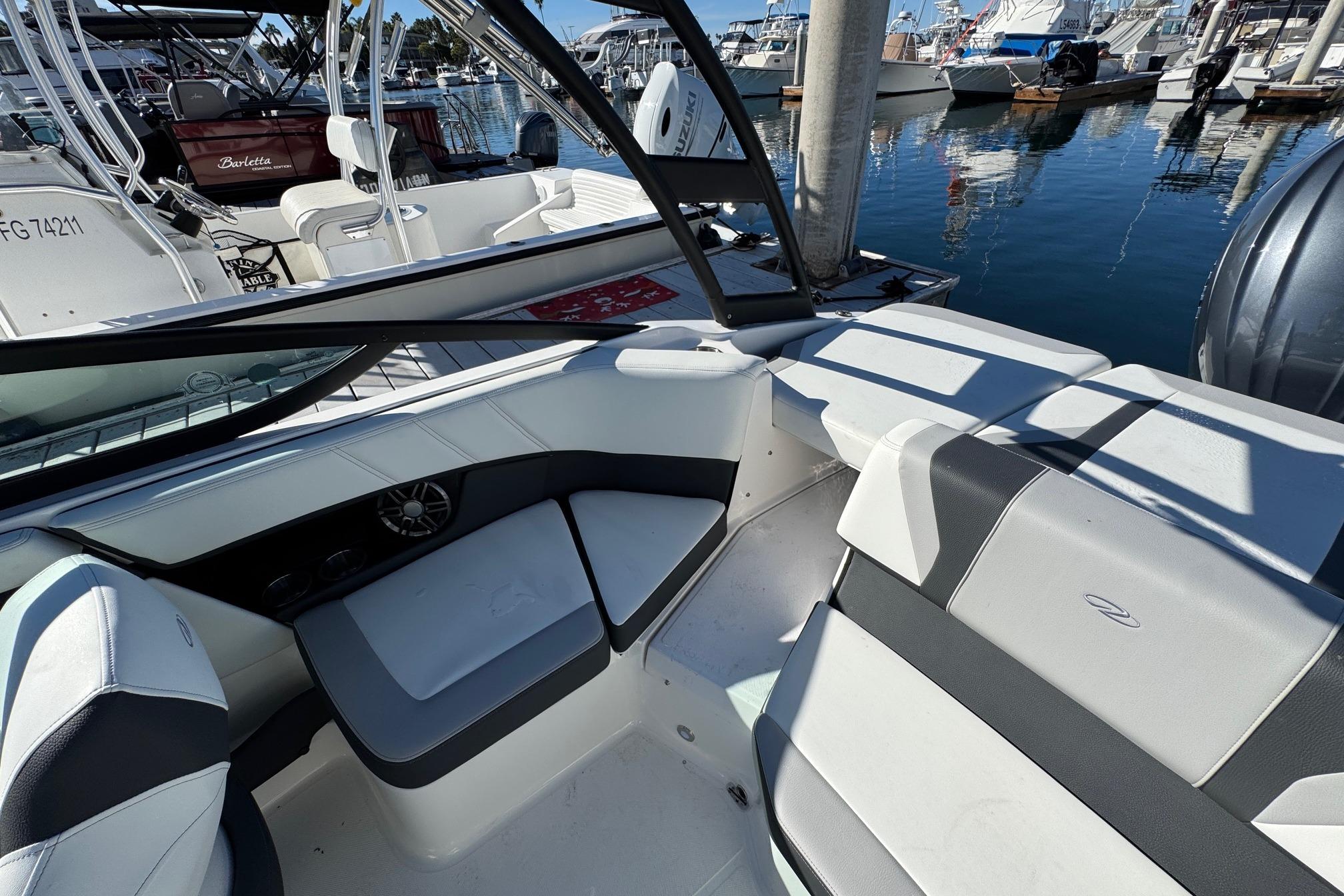 2026 Regal 21 OBX boat interior with sleek seating, docked at a marina.