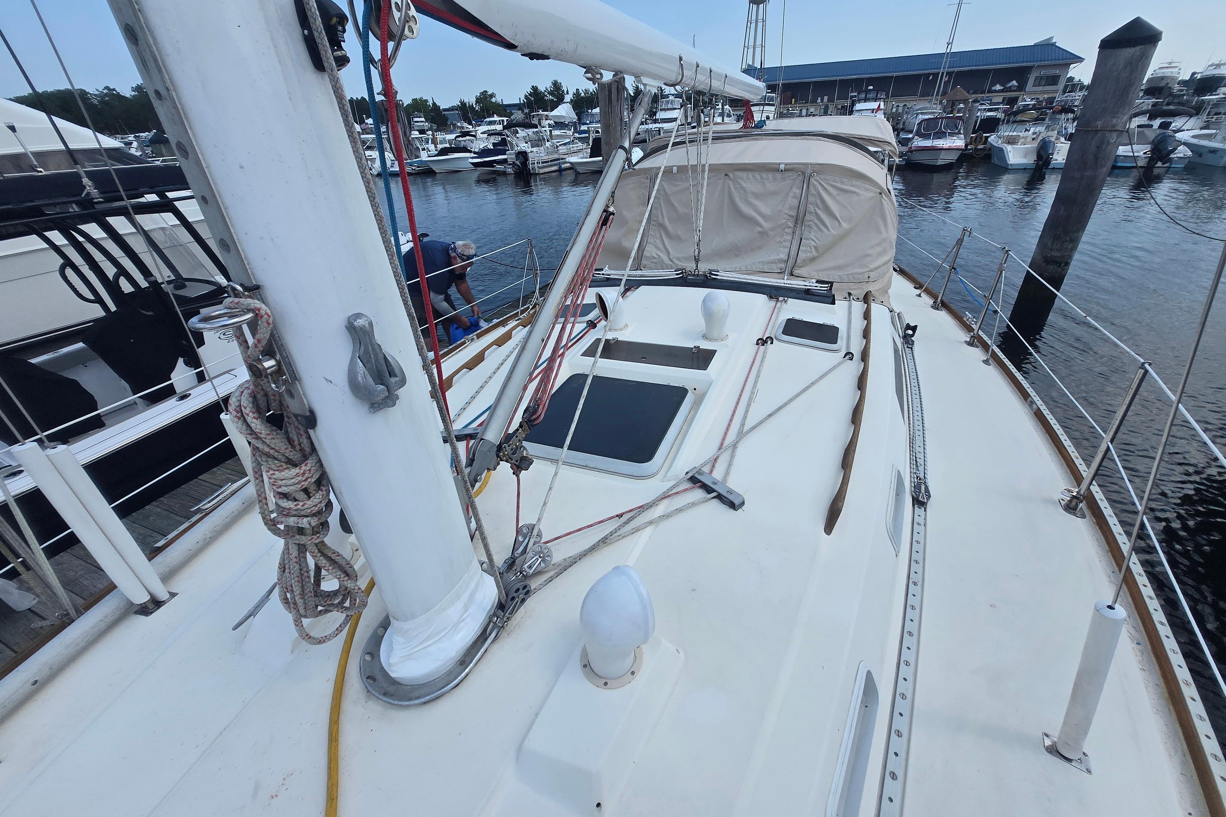 1988 Sabre 38 sailboat deck view at marina, showcasing rigging and hatches.