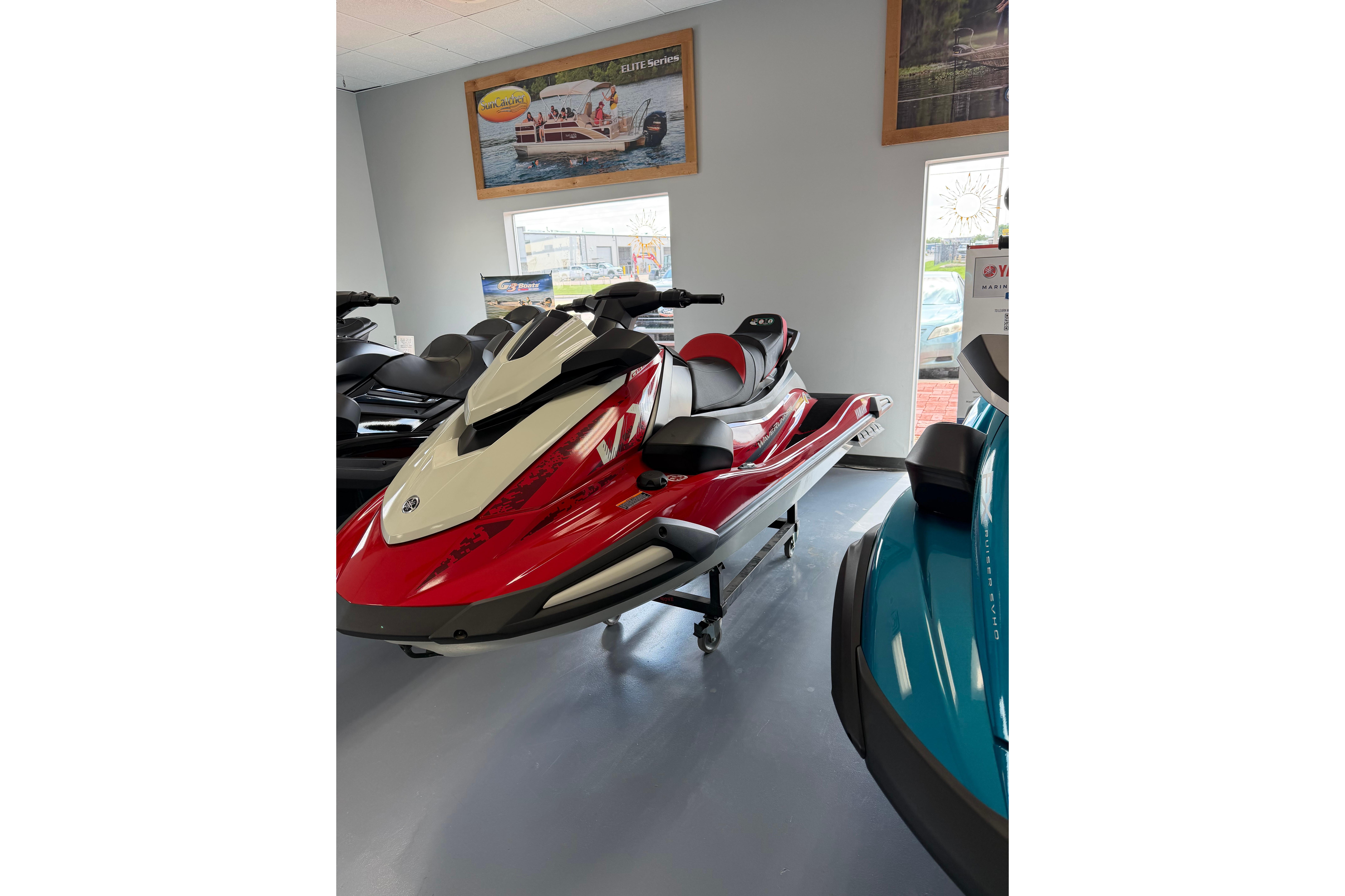 2026 Yamaha WaveRunner VX Cruiser in showroom, red and white design, sleek and modern.