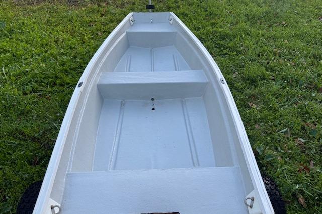 1999 Beacon Boats Pram on grass, showcasing interior seating and structure.