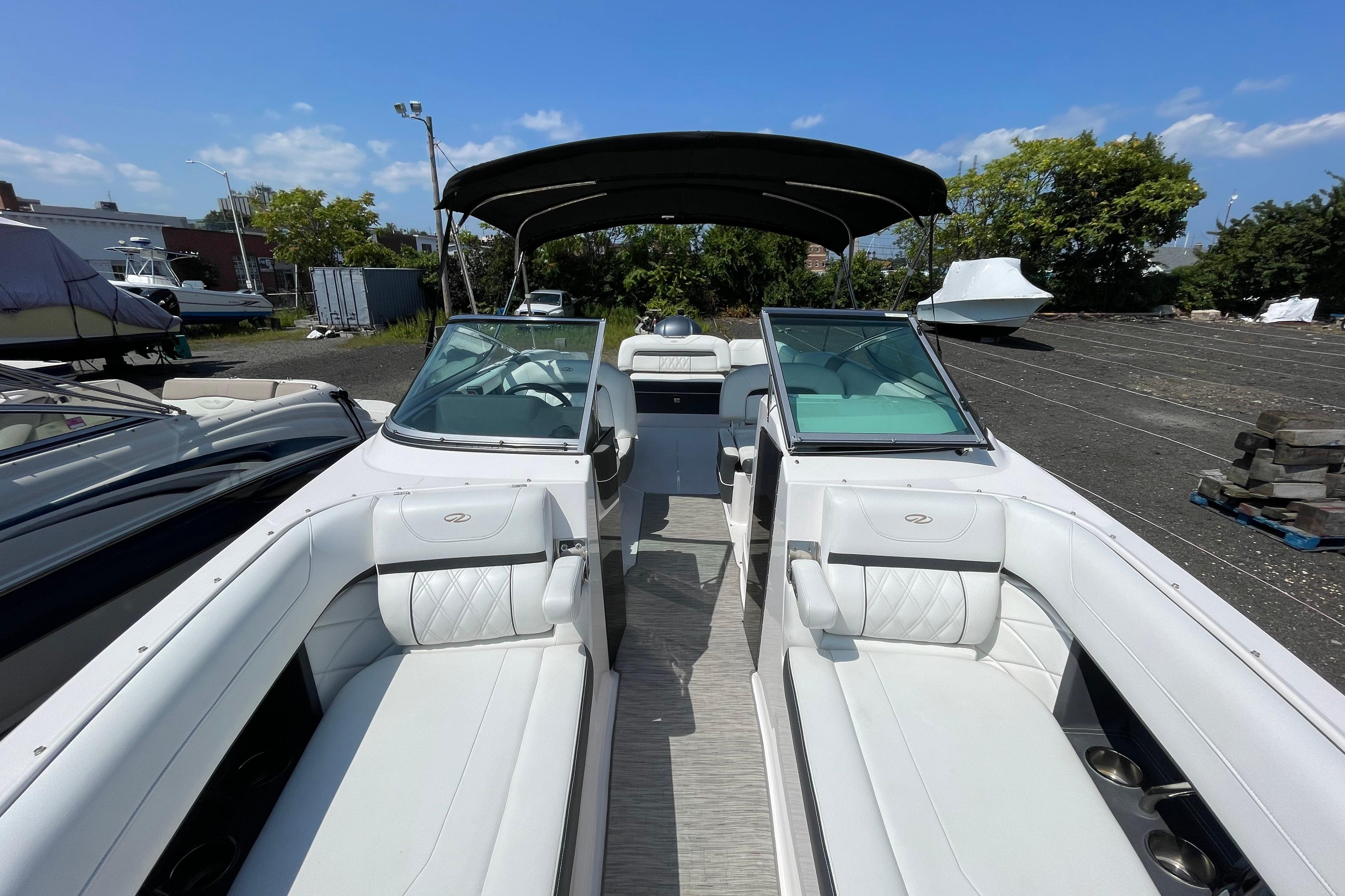 2018 Regal 26 OBX boat with white interior and canopy, parked outdoors.