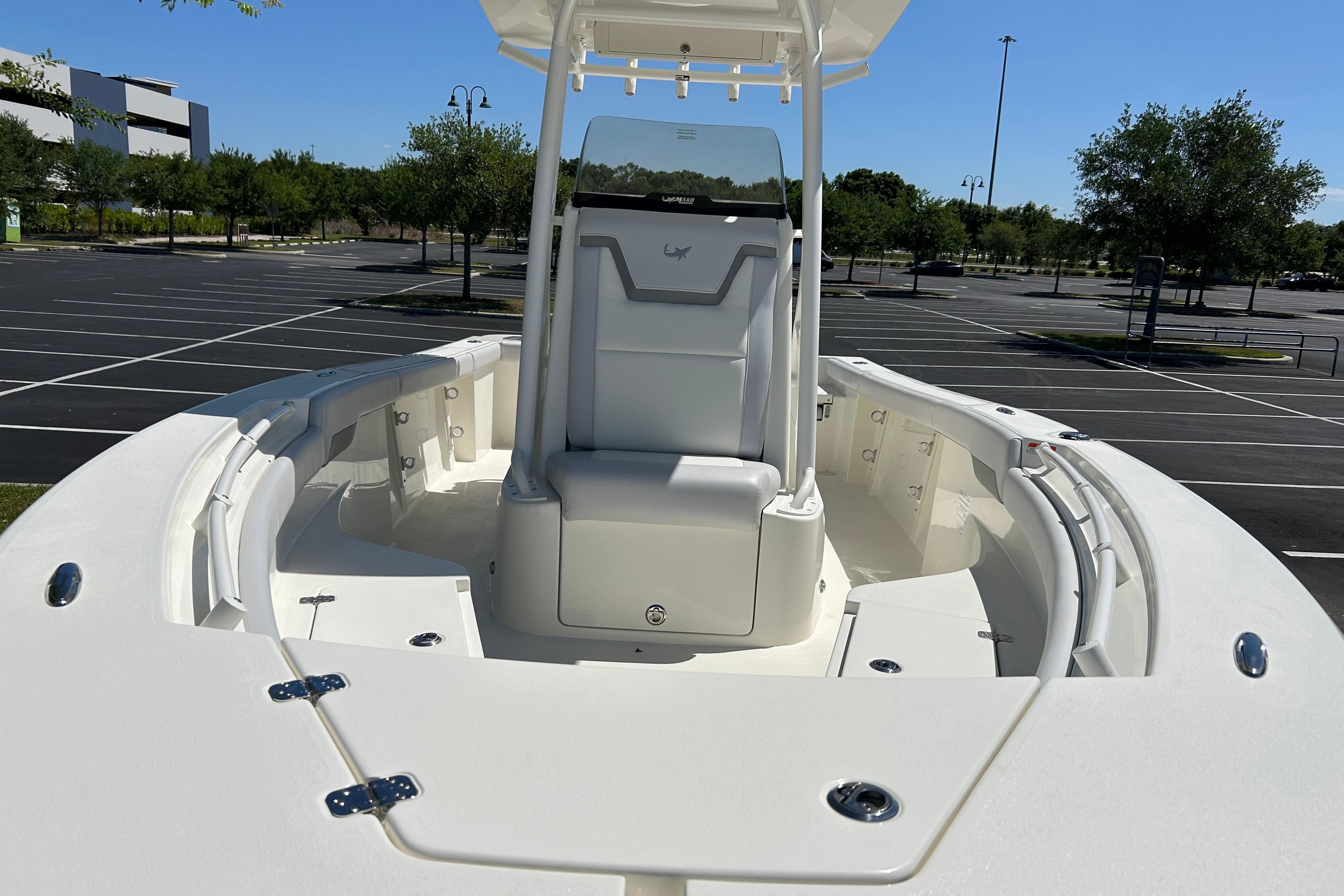 2026 Mako 226 Center Console boat in a parking lot, showcasing sleek design and spacious seating.