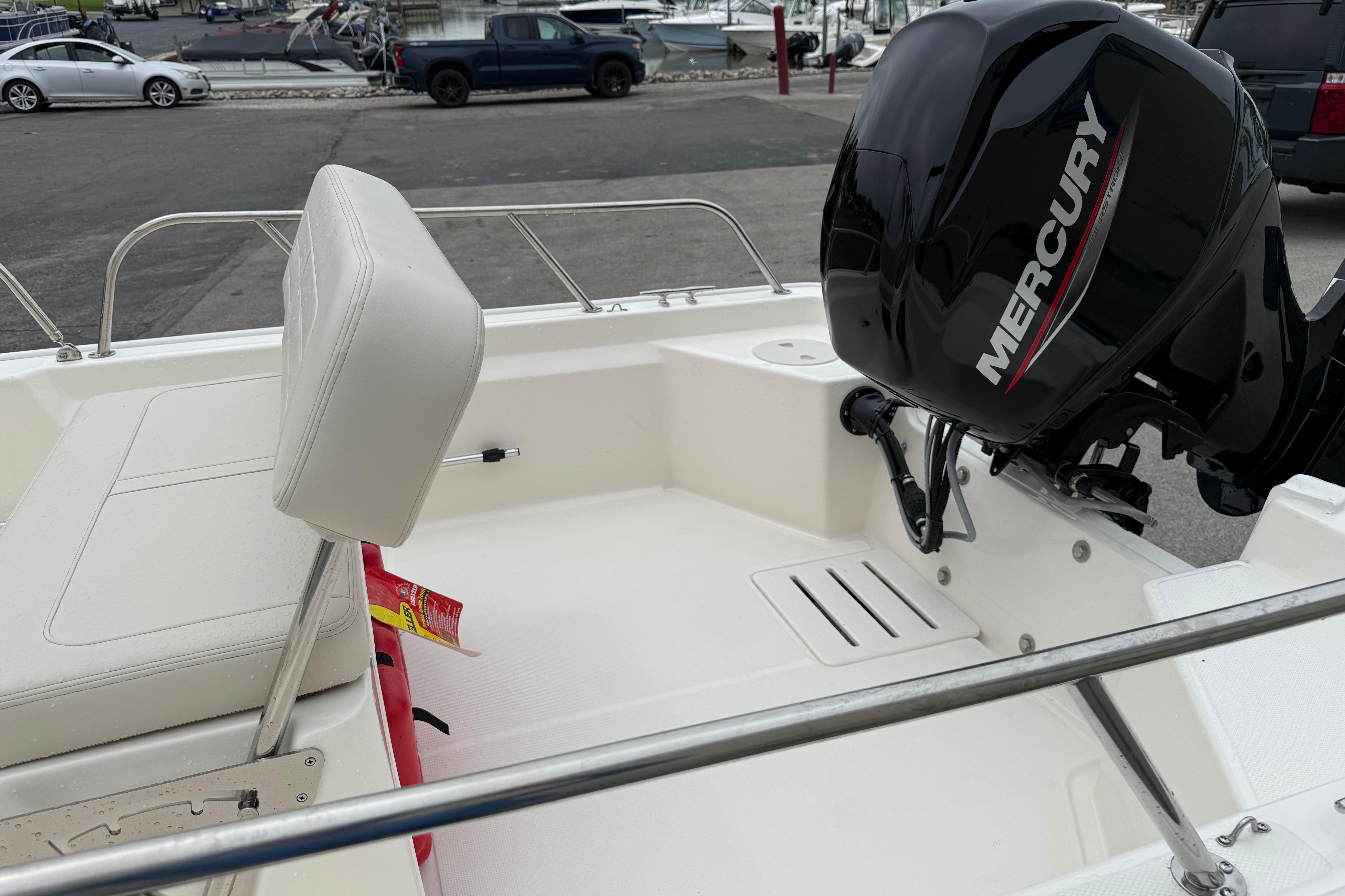 2026 Boston Whaler 150 Montauk boat with Mercury engine at marina.
