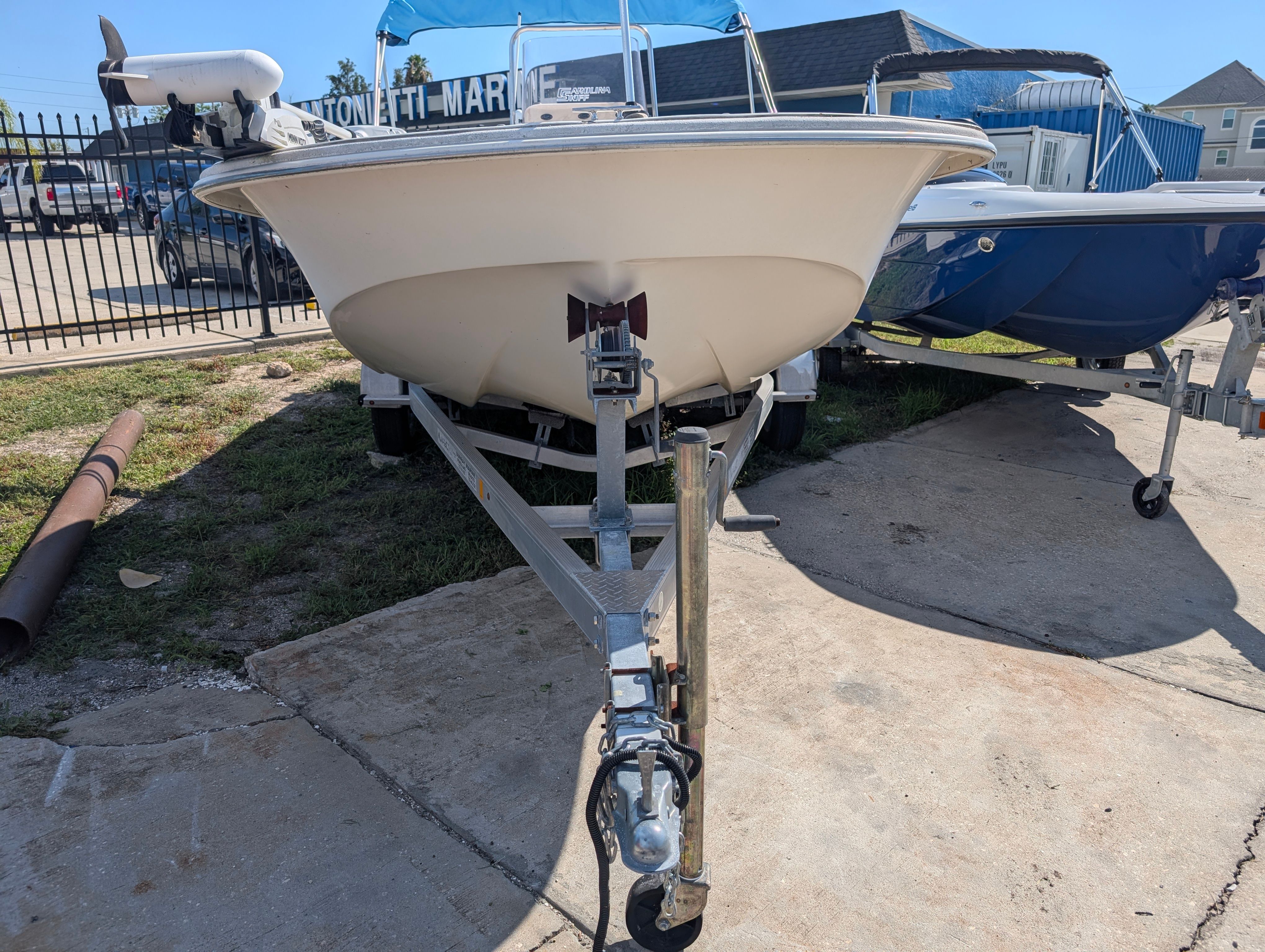 A 2016 Carolina Skiff 198 DLV is on a trailer. It is situated in an outdoor area.