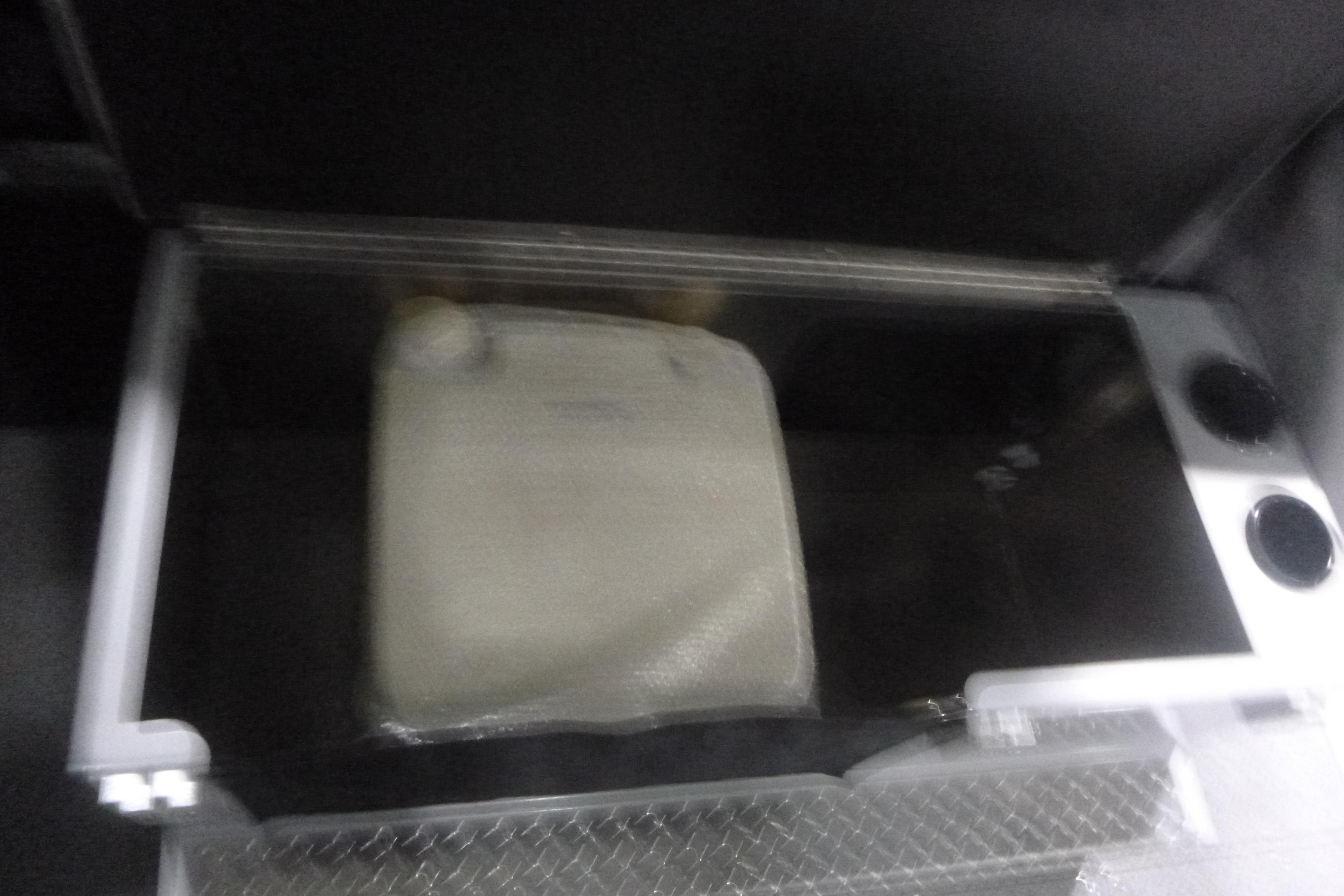 Storage compartment in 2026 KingFisher 2425 Escape HT boat, featuring a secure lid and cup holders.