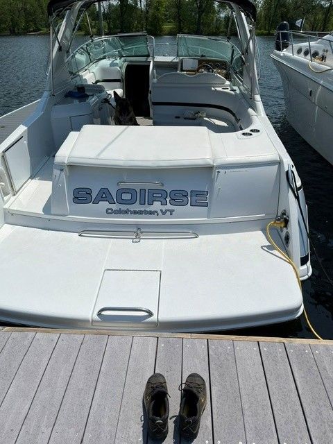 2006 Formula 330 Sun Sport boat docked with shoes on deck.