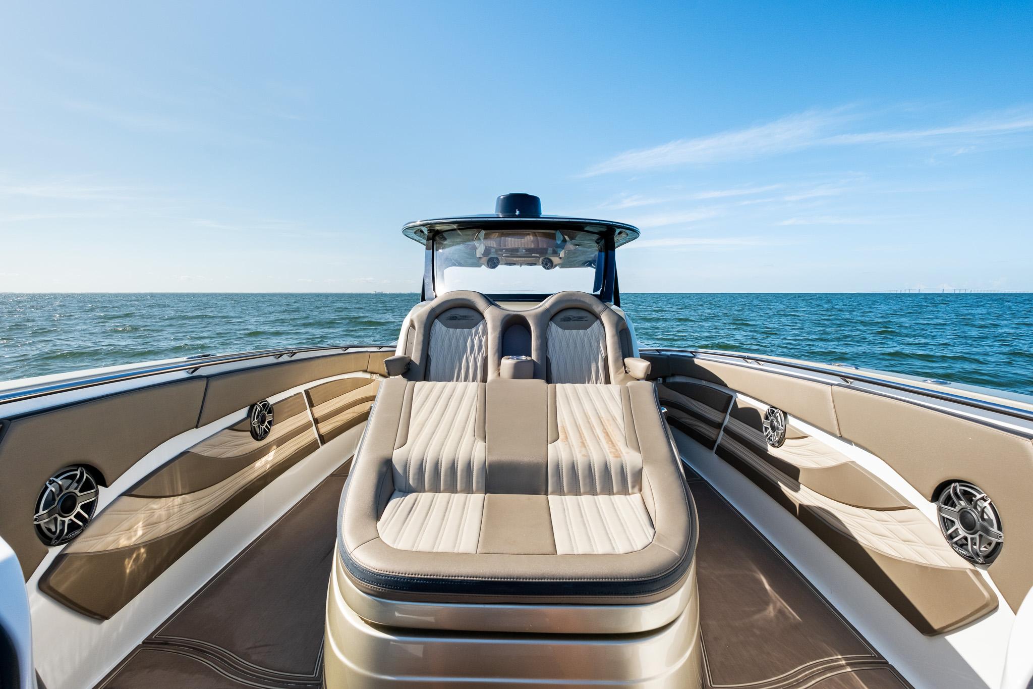 Luxury MTI V42 boat interior with plush seating, ocean view, and sleek design, 2021 model.